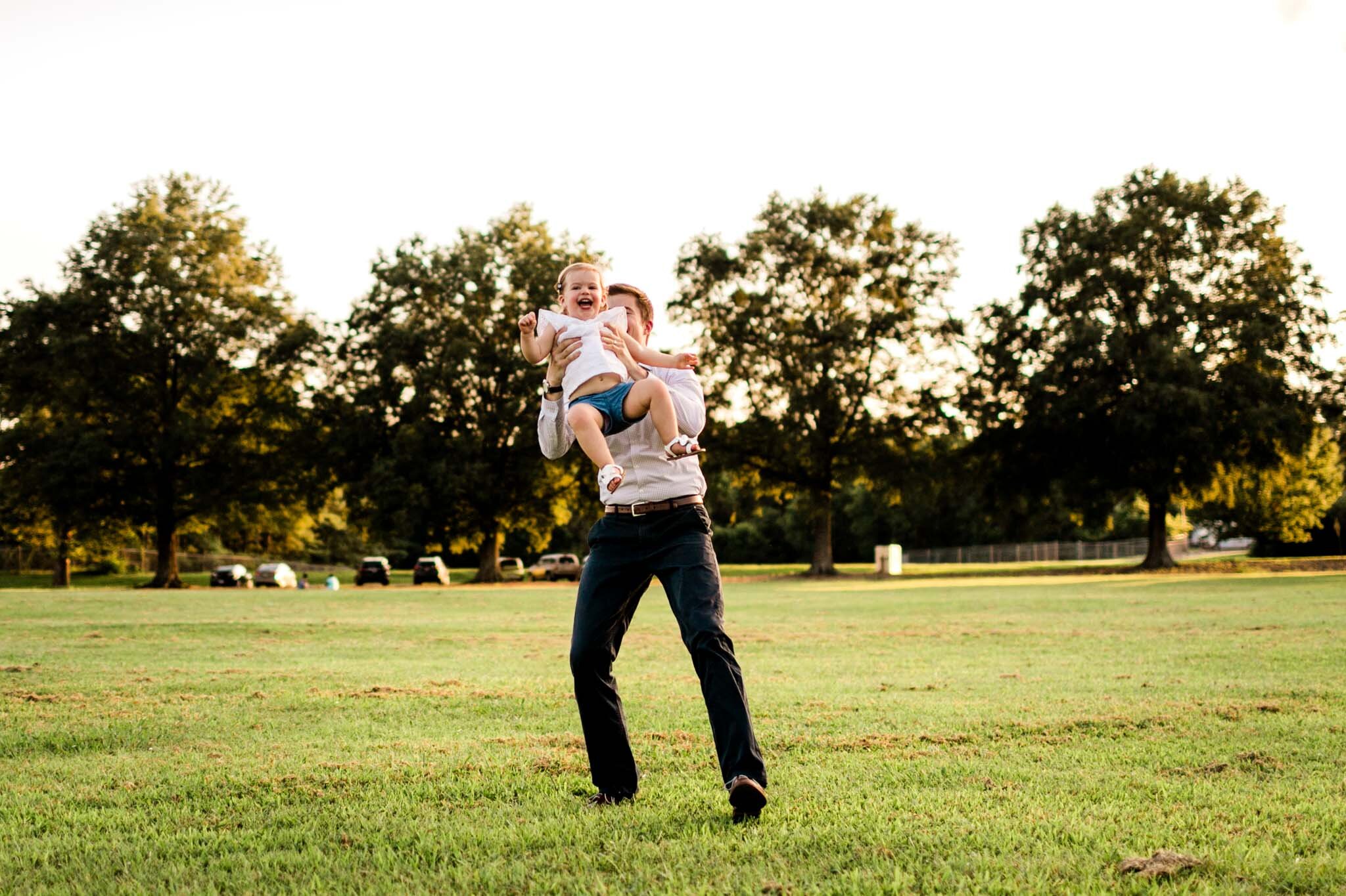 Raleigh Family Photography at Dix Park | By G. Lin Photography | Dad throwing daughter in the air