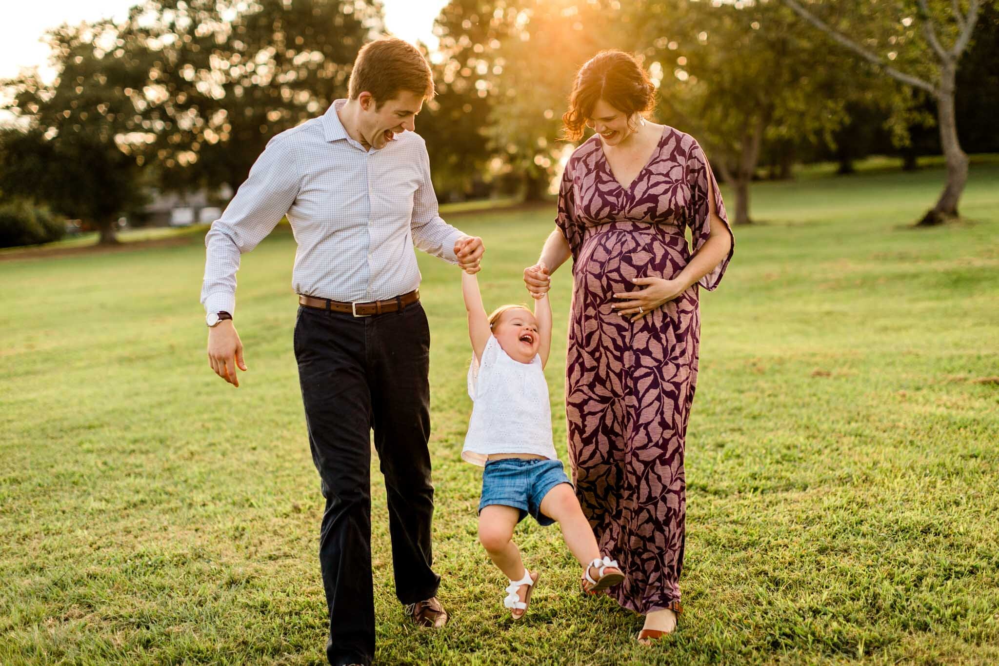 Raleigh Family Photographer | By G. Lin Photography | Family smiling and laughing together swinging little girl