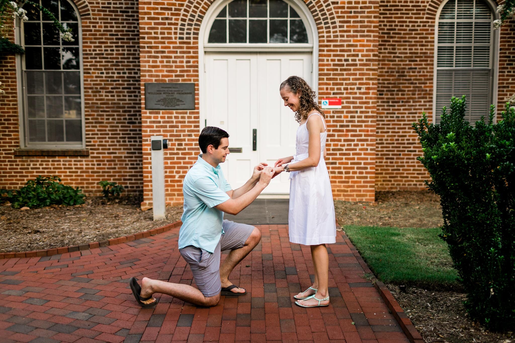 Raleigh Engagement Photographer | NC State University | By G. Lin Photography | Man putting engagement ring on woman