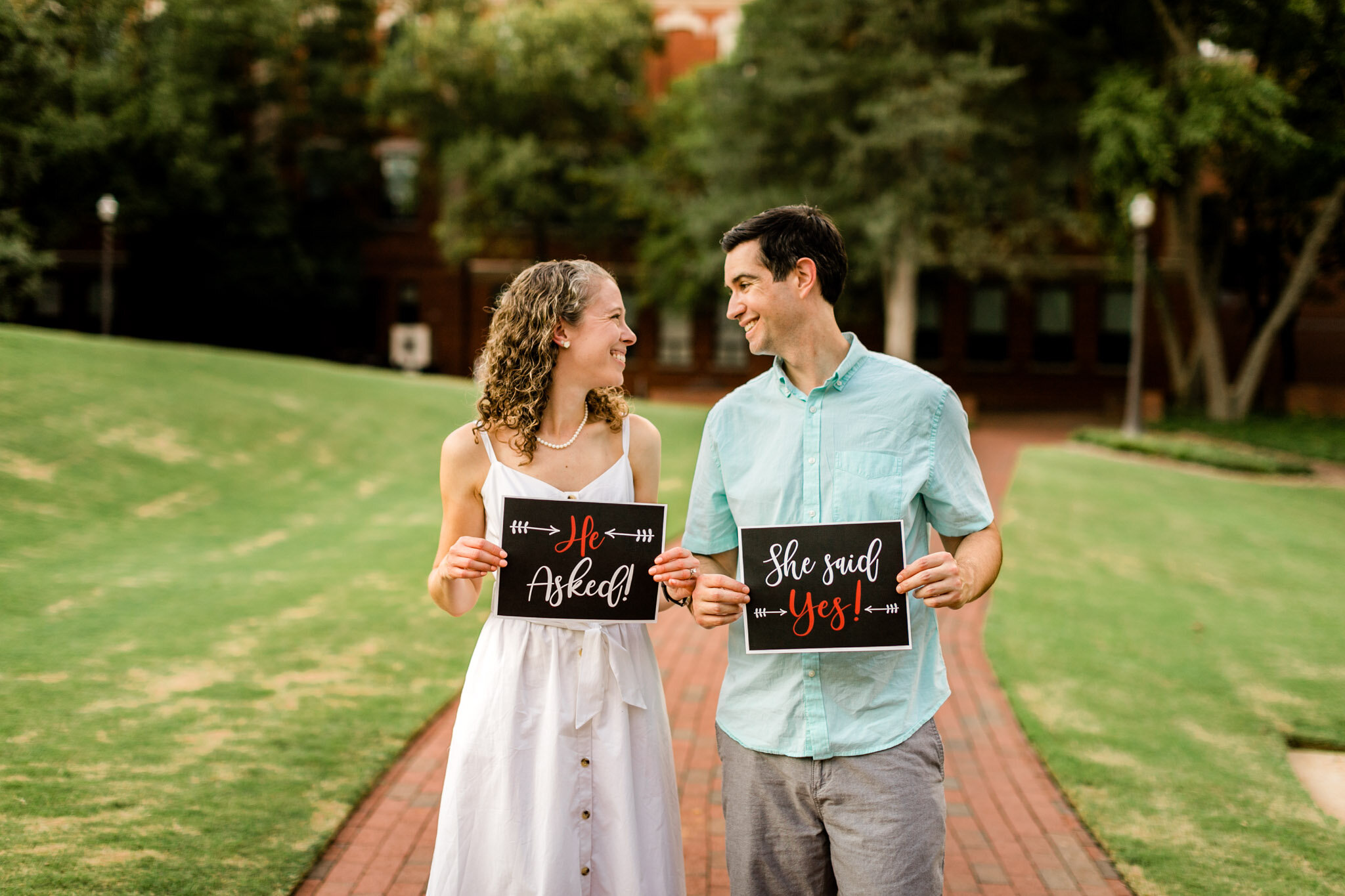 Raleigh Engagement Photographer | NC State University | By G. Lin Photography | Couple holding signs of engagement