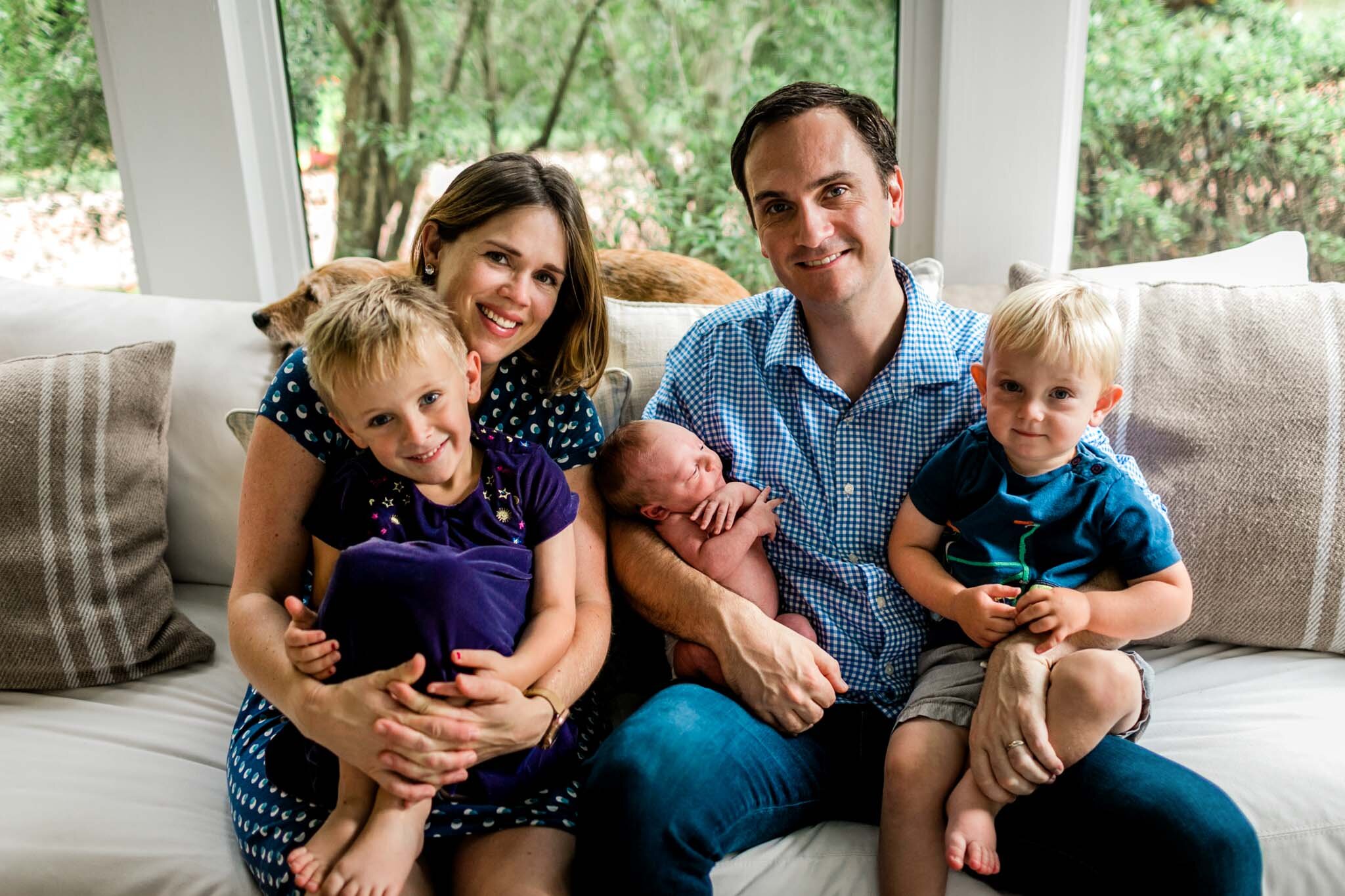 Durham Newborn Photographer | By G. Lin Photography | Family sitting on sofa and looking at camera