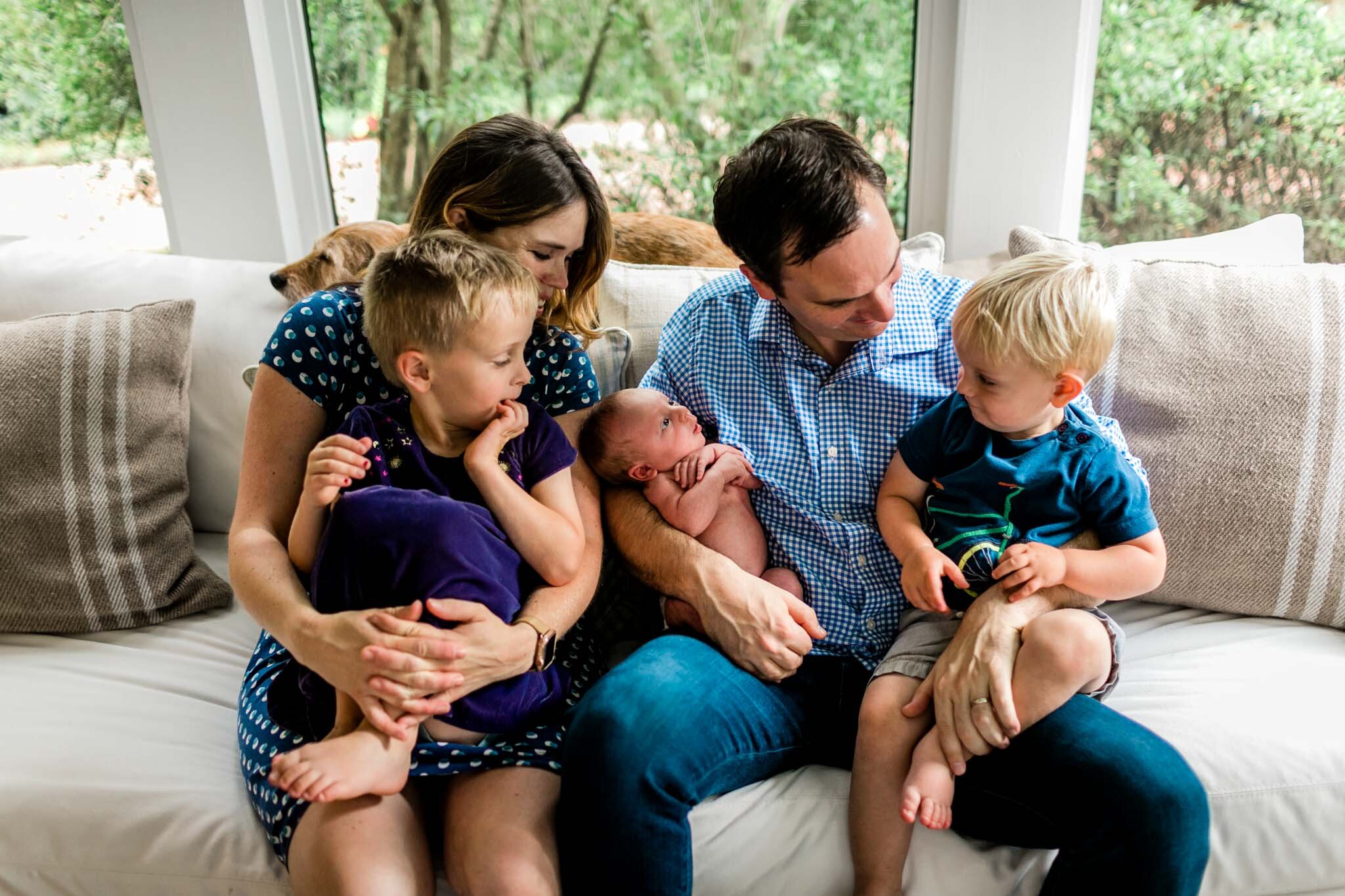 Durham Newborn Photographer | By G. Lin Photography | Lifestyle newborn session at home | Family looking at each other and laughing