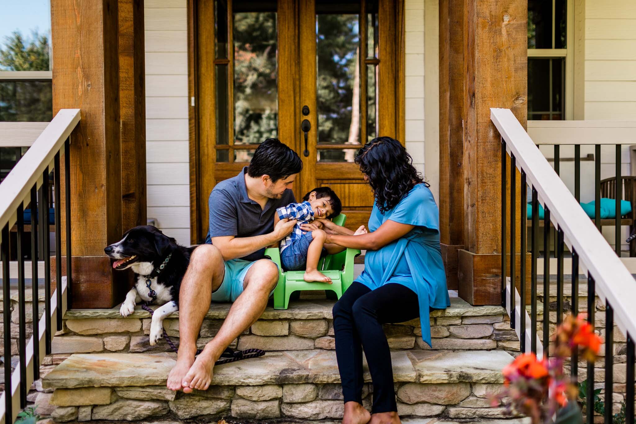Durham Family Photographer | By G. Lin Photography | Family tickling son in front of house and laughing