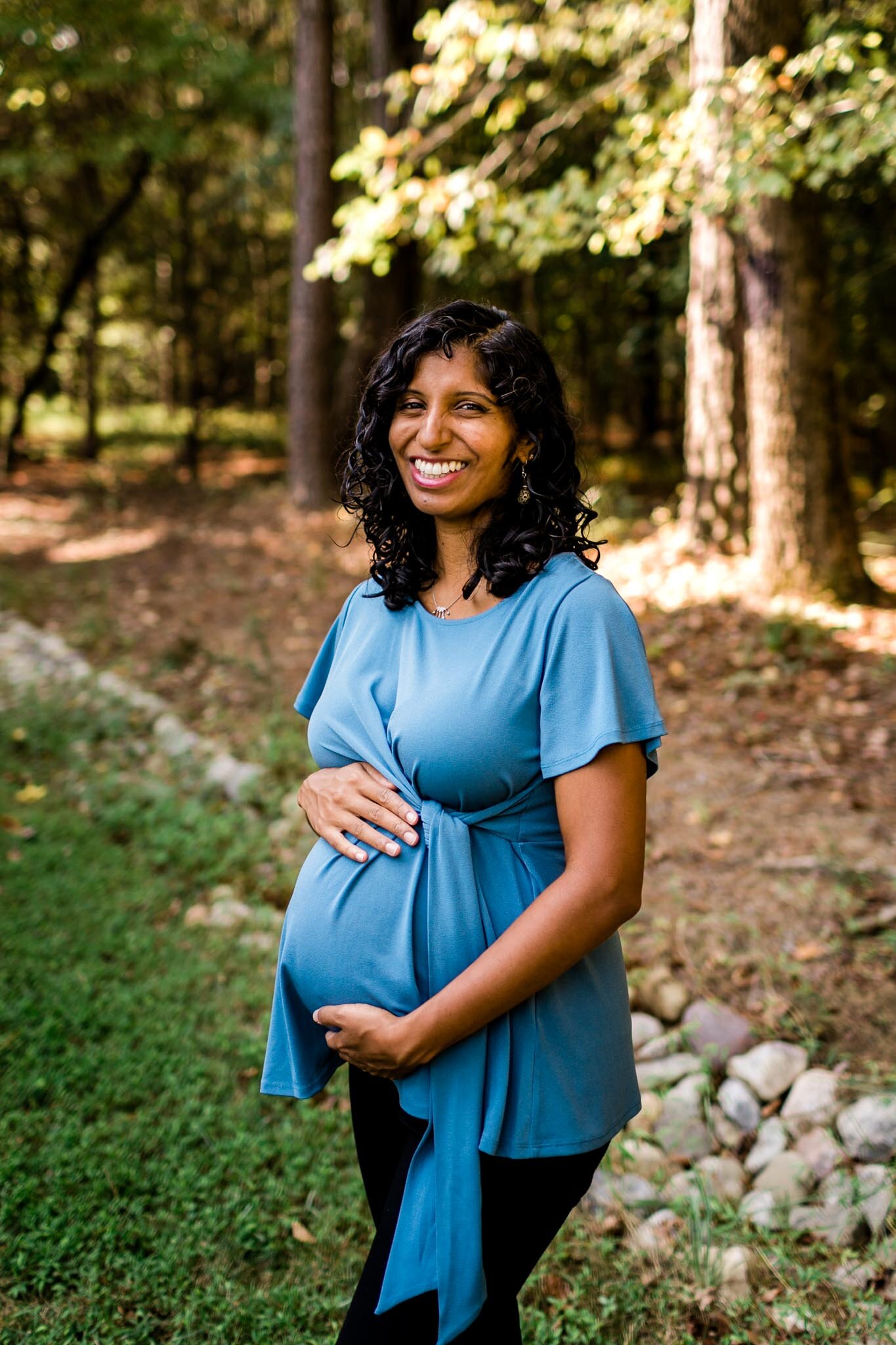 Durham Maternity Photographer | By G. Lin Photography | Pregnant woman outside for maternity photo and smiling