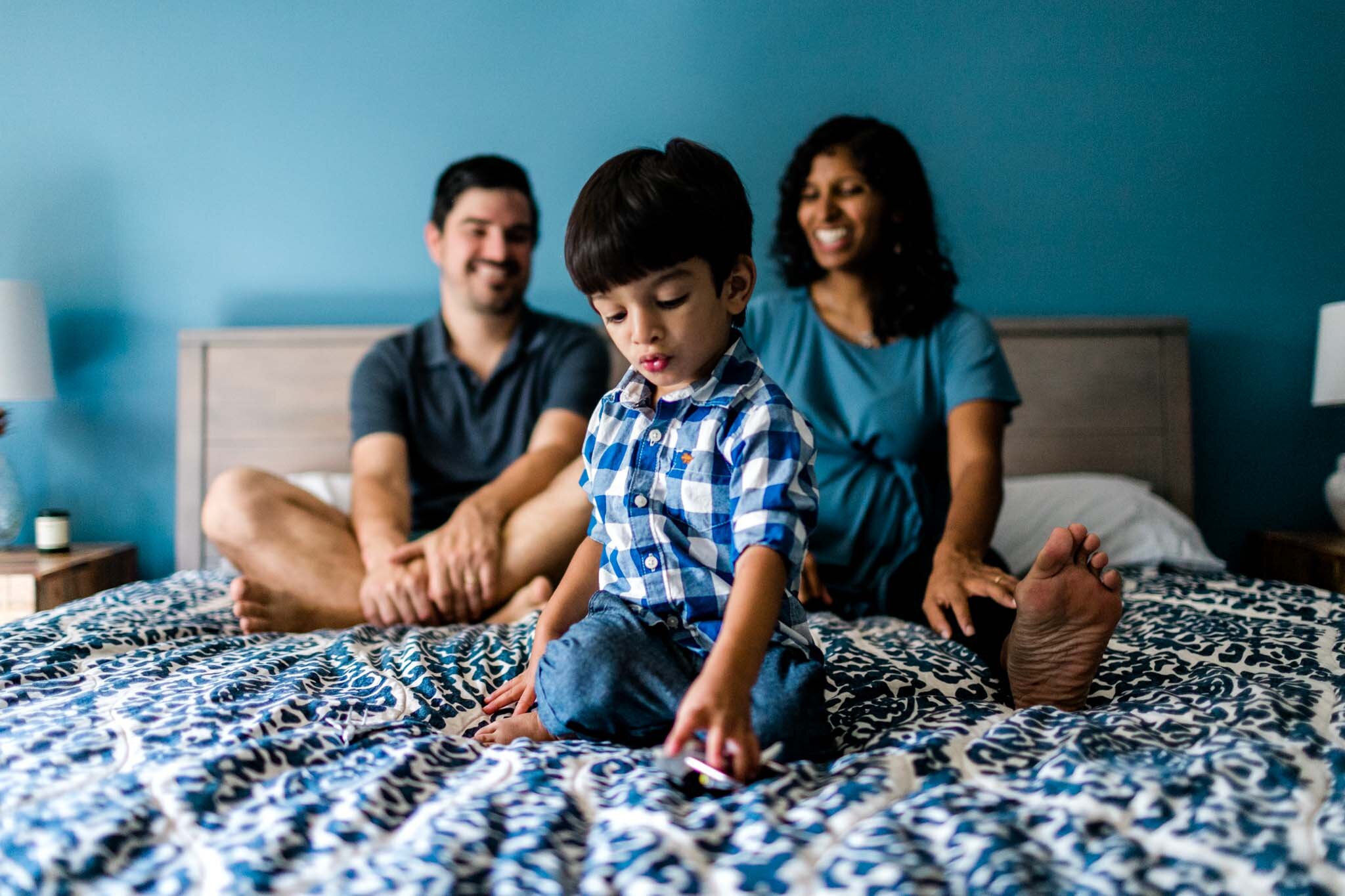 Lifestyle Durham Family Photographer | By G. Lin Photography | Boy playing with toy airplanes on bed