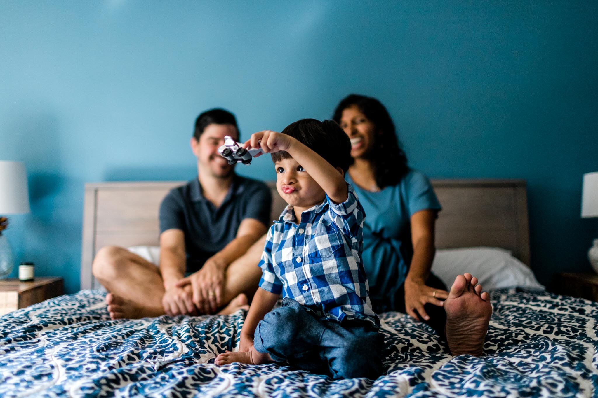 Raleigh Family Photographer | By G. Lin Photography | Family playing with toys on bed