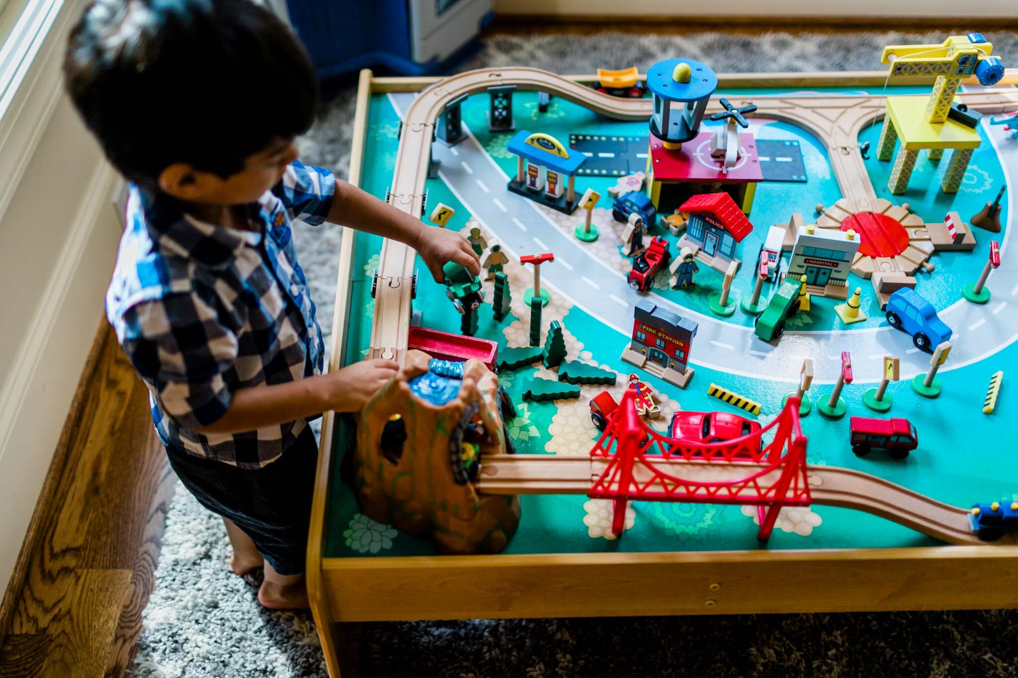 Durham Photographer | By G. Lin Photography | Child playing with train set