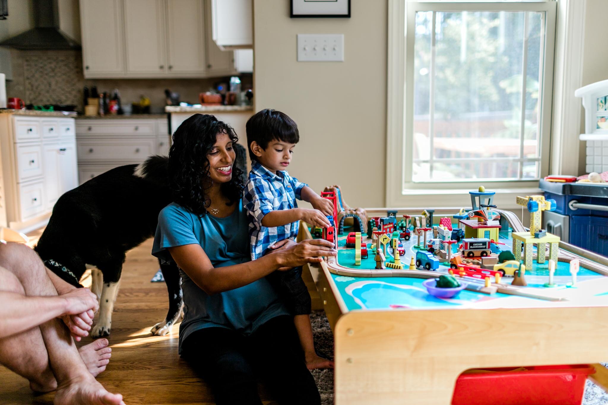 Raleigh Family Photographer | By G. Lin Photography | Mom playing with son and building train set