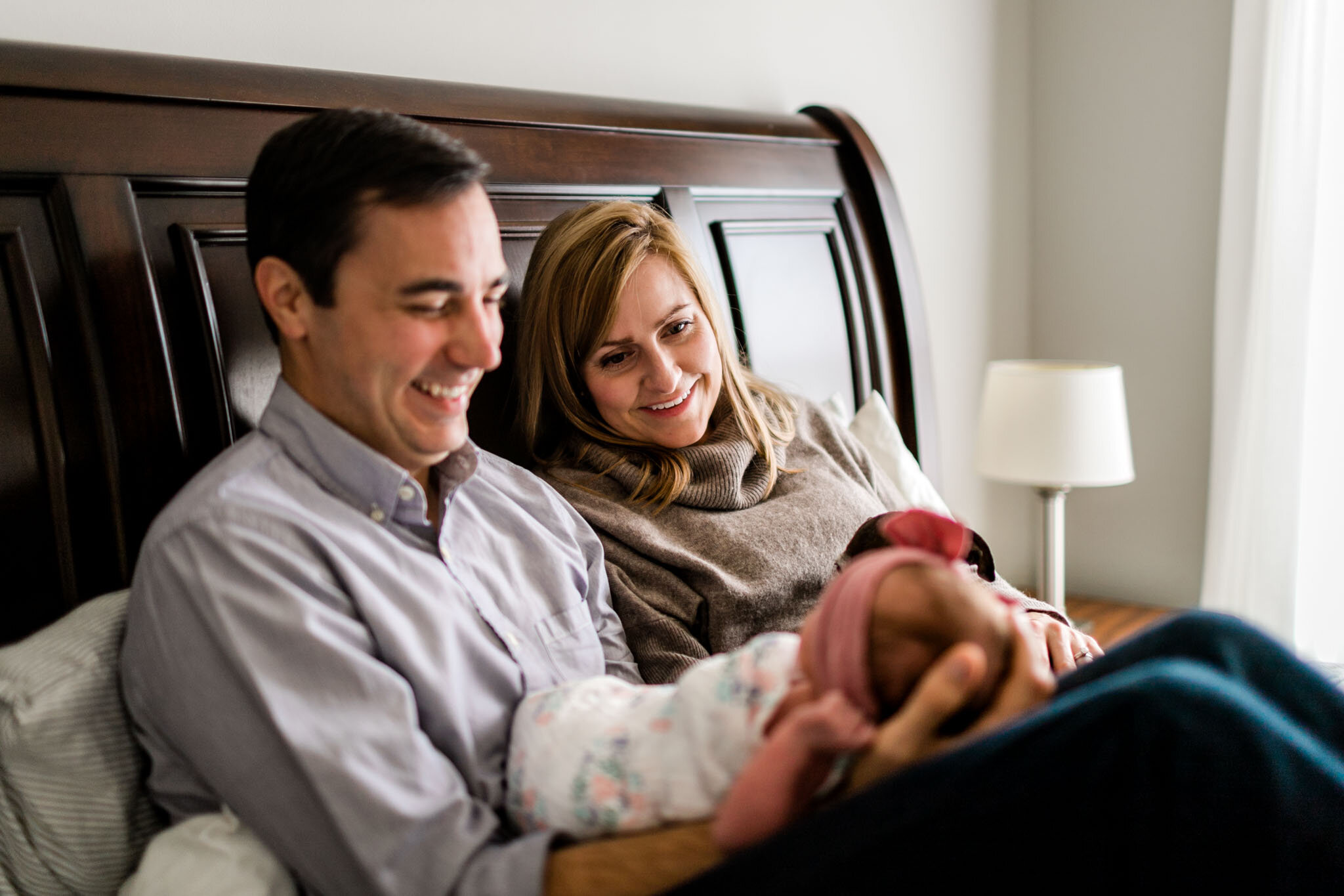 Father smiling at newborn girl during lifestyle home session | Durham Newborn Photographer | By G. Lin Photography 