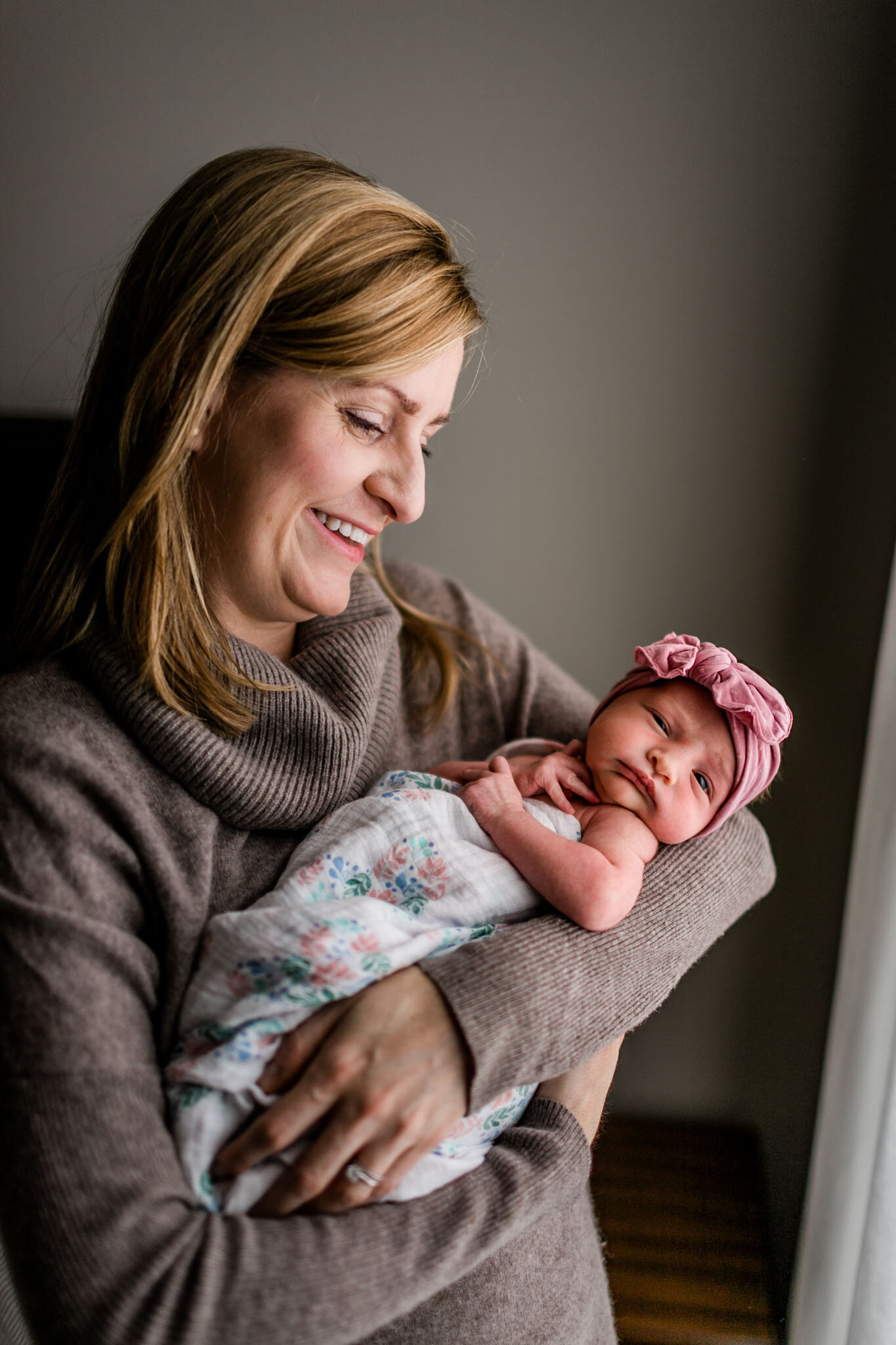 Mother holding baby girl by window light | Durham Newborn Photographer | By G. Lin Photography 