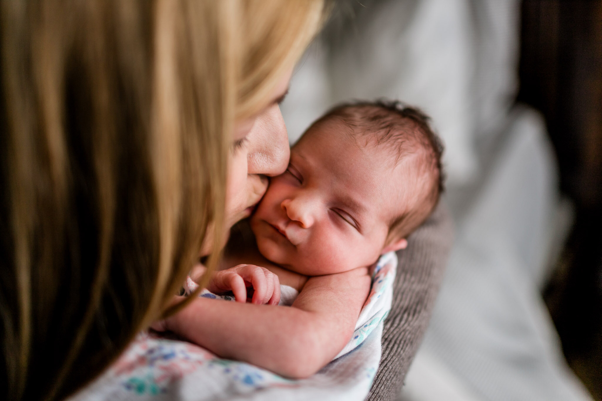 Raleigh Newborn Photographer | By G. Lin Photography | Mother kissing baby girl on cheek