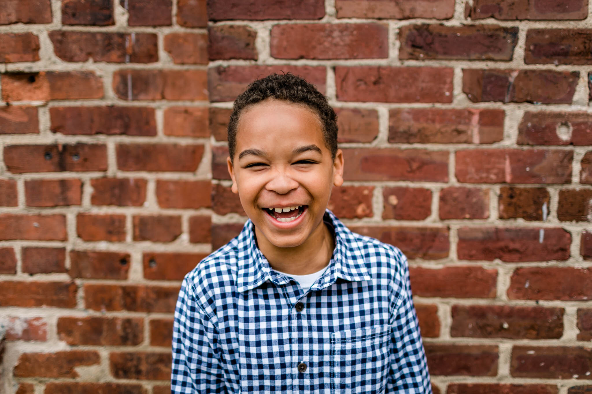 Candid portrait of young boy laughing | Durham Family Photographer | By G. Lin Photography