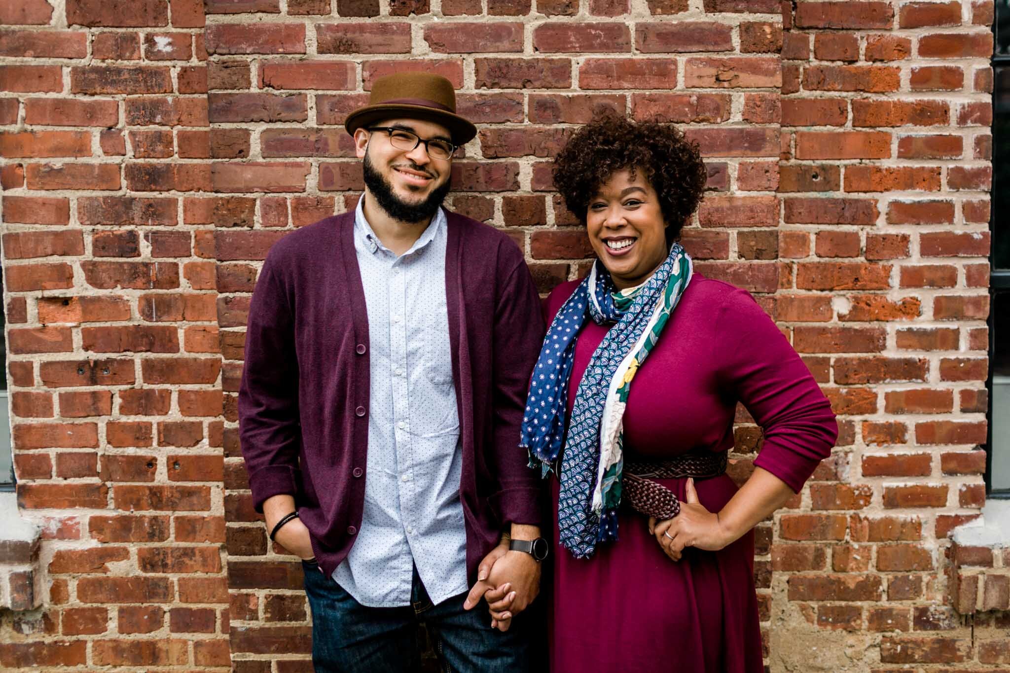 Durham Photographer | By G. Lin Photography | Couple standing and smiling against brick wall