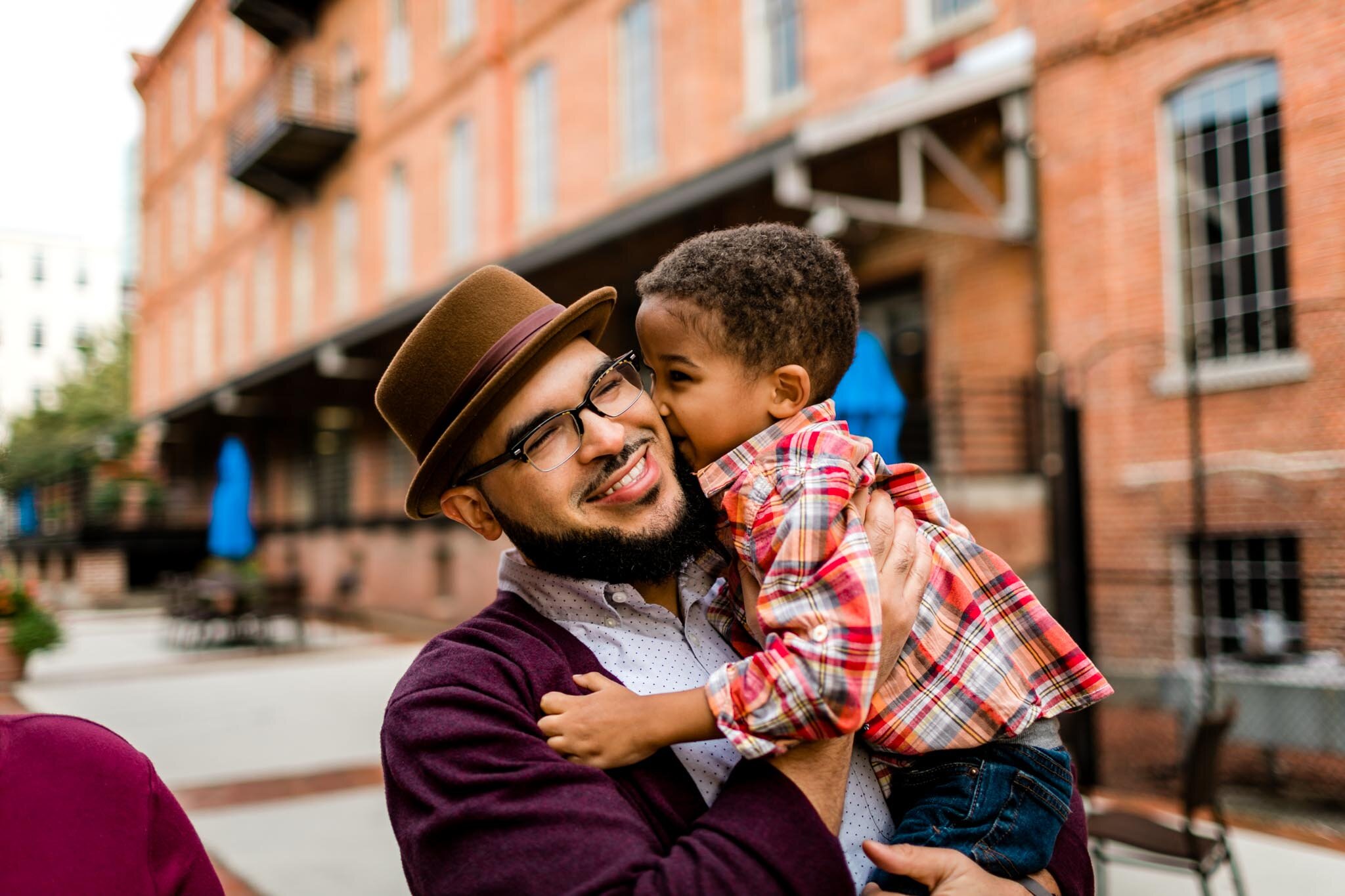 Young boy kissing dad on the cheek | Durham Photographer | By G. Lin Photography