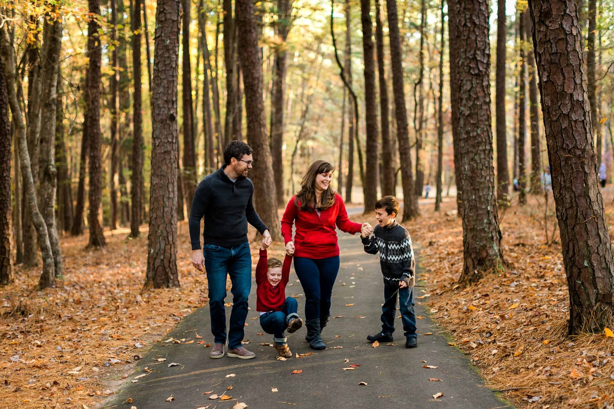 Candid family photo walking together at Umstead Park | Raleigh Family Photographer | By G. Lin Photography