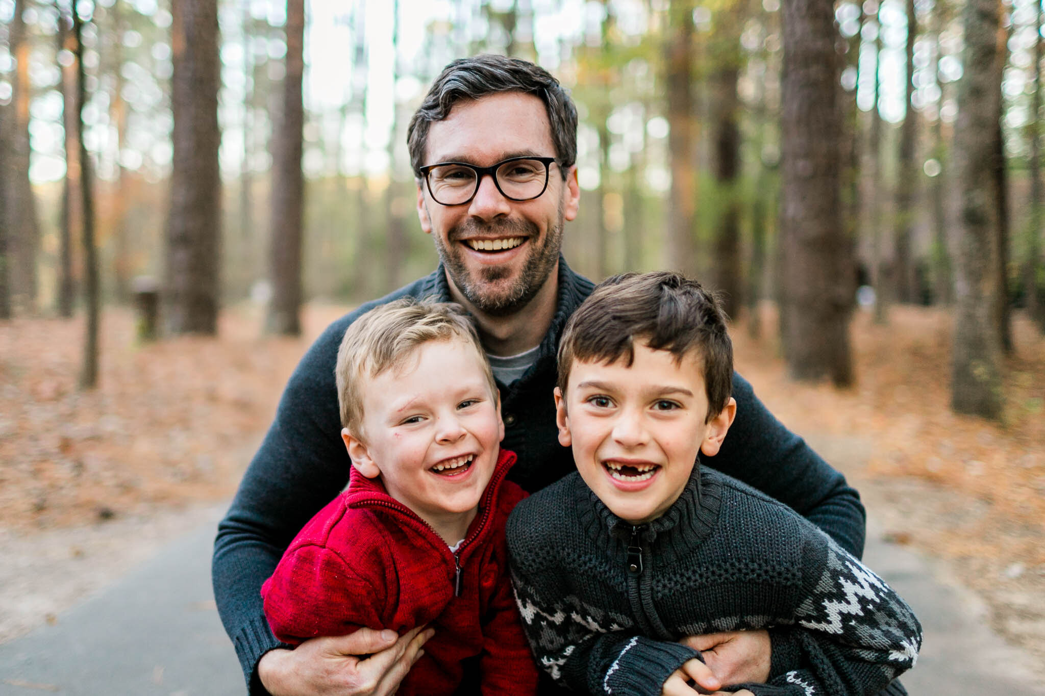 Raleigh Family Photographer | By G. Lin Photography | Dad hugging two sons at park outside