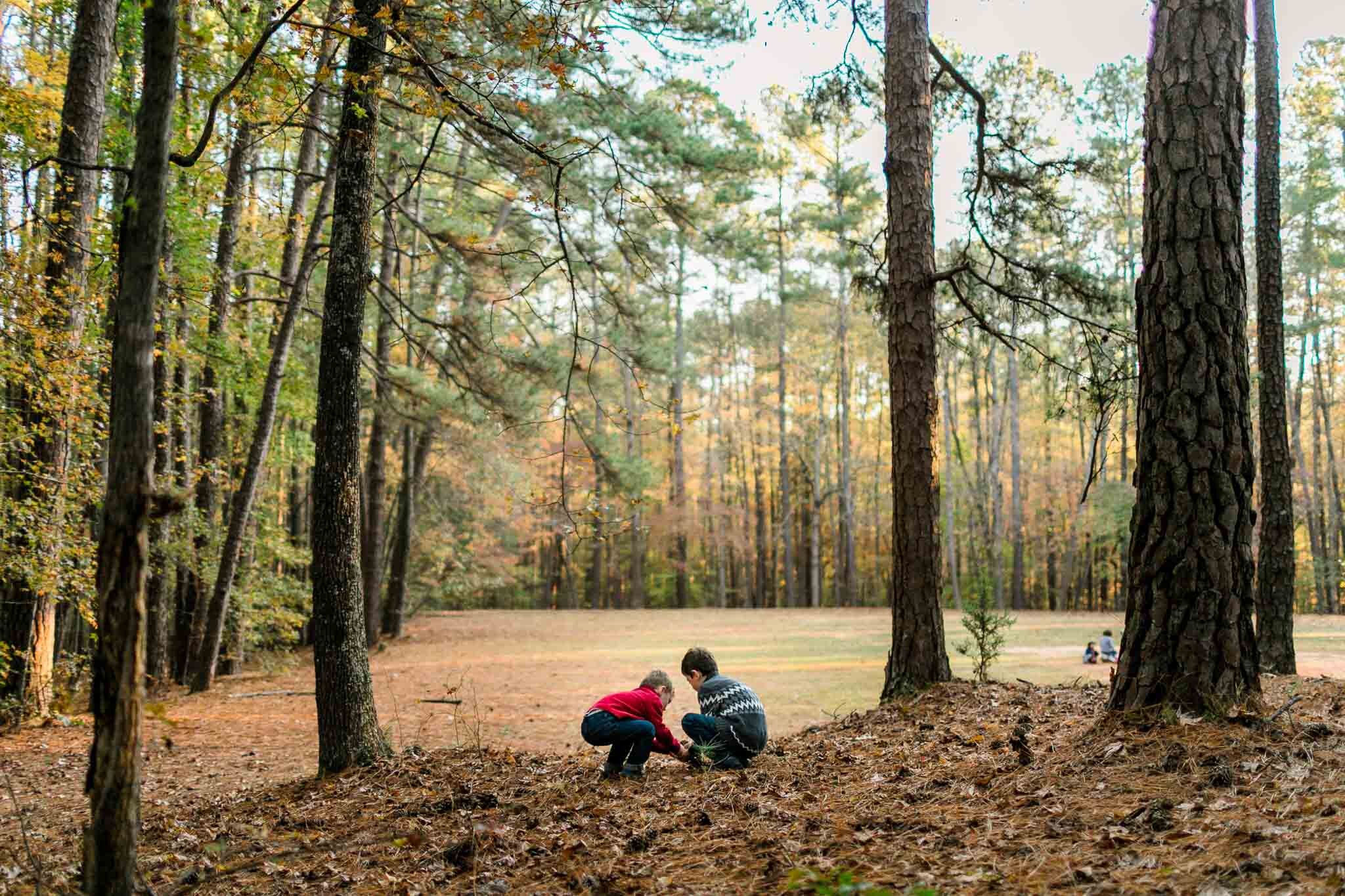Raleigh Family Photographer | By G. Lin Photography | Two boys putting a toad back at park