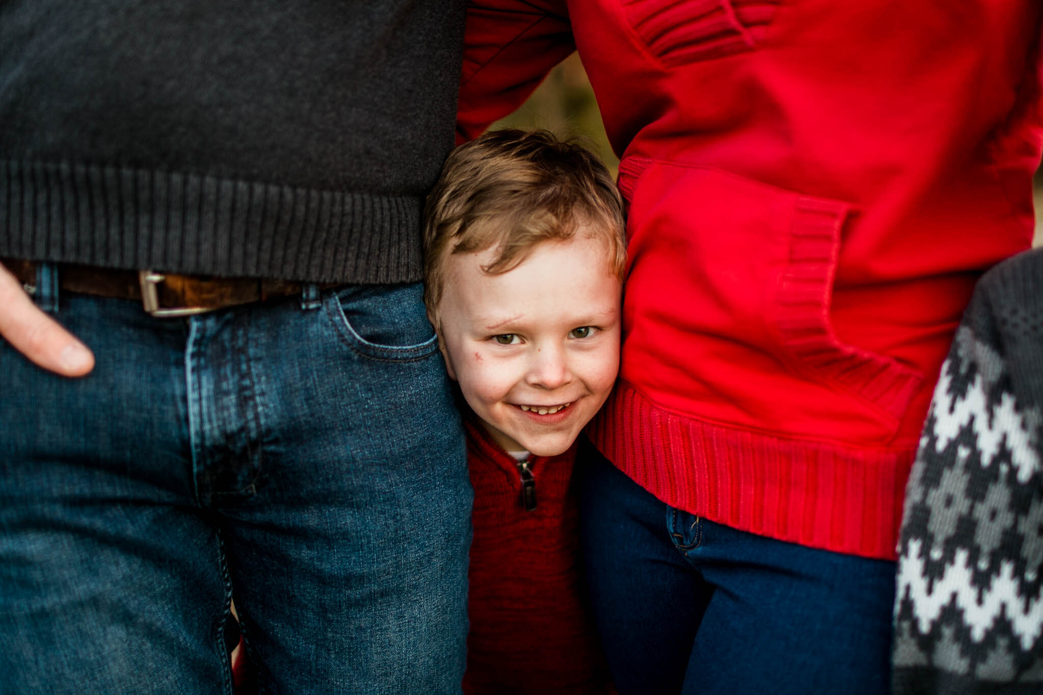 Raleigh Family Photographer | By G. Lin Photography | Young boy peeking out between parents