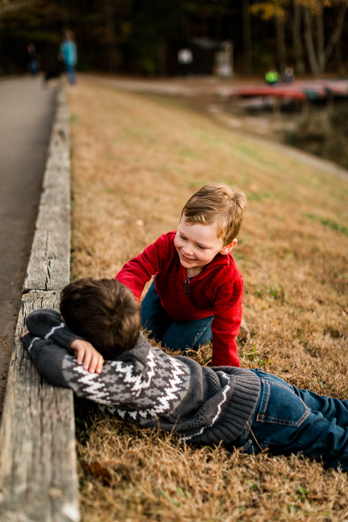 Raleigh Family Photographer | By G. Lin Photography | Young brothers playing with one another on grass