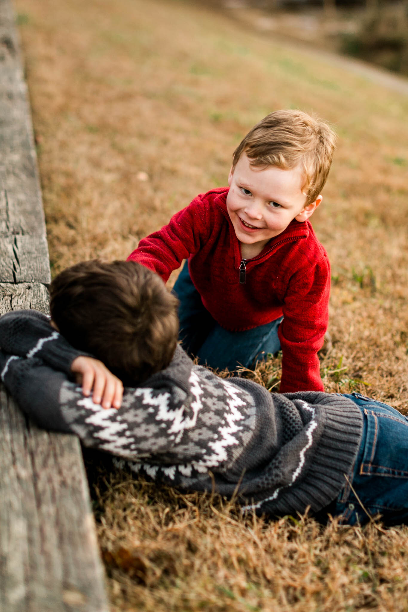 Raleigh Family Photographer | By G. Lin Photography | Candid portrait of boys playing on the grass