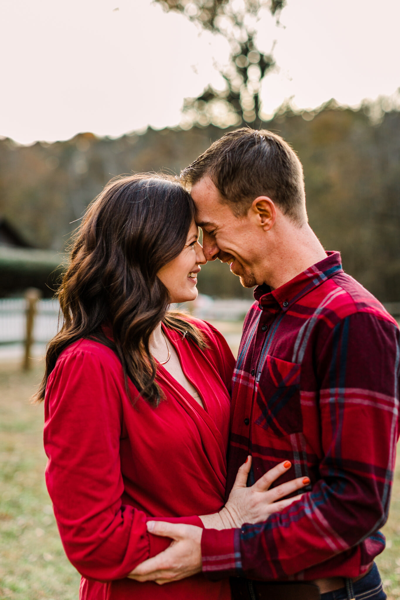 Durham Photographer | By G. Lin Photography | West Point on Eno River | Couple laughing outside together and embracing one another | West Point on Eno River