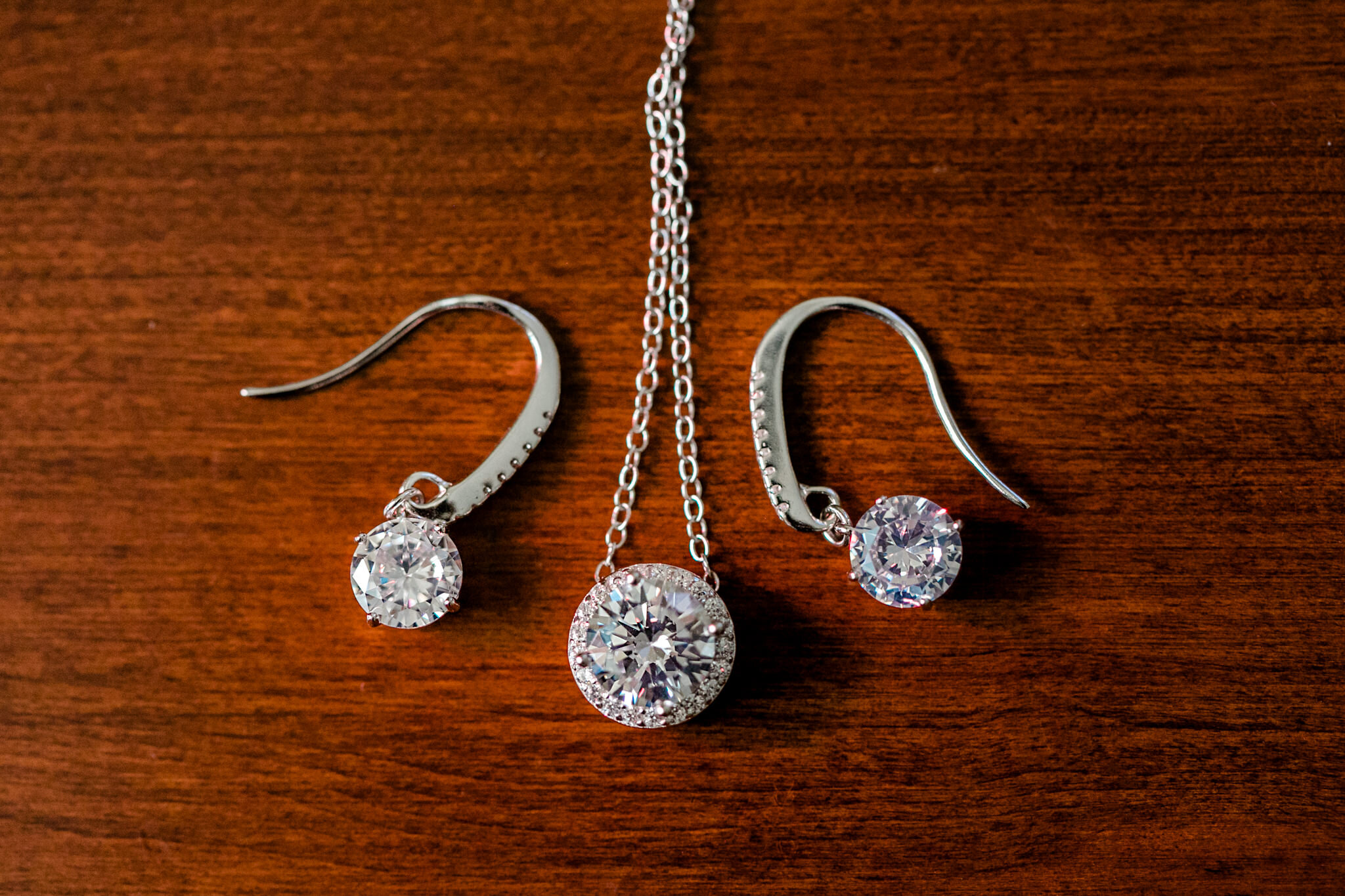 Durham Wedding Photographer | By G. Lin Photography | Close up of bridal necklace and earrings on wooden table