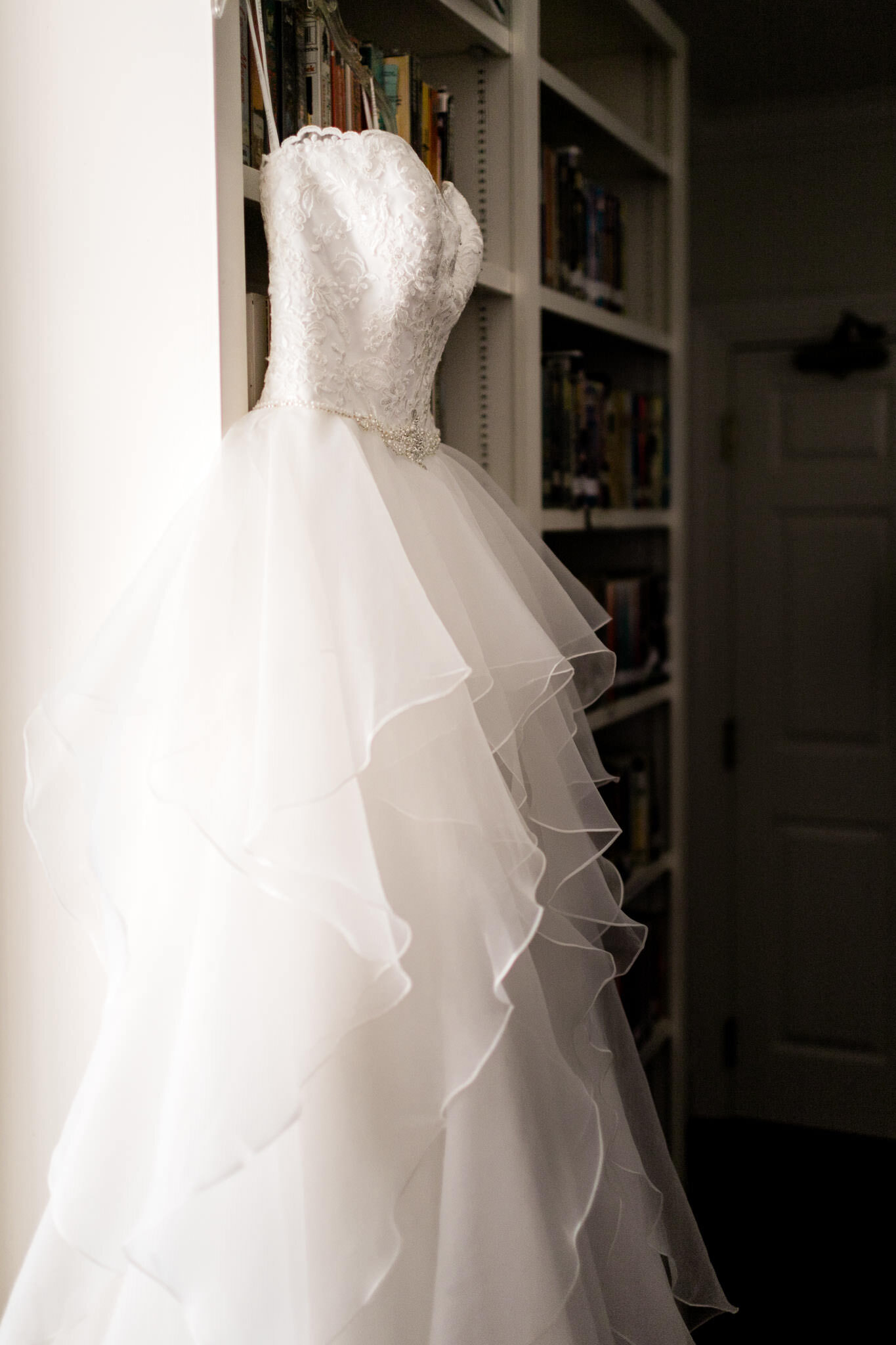 Durham Wedding Photographer | By G. Lin Photography | Wedding dress hanging by bookshelf