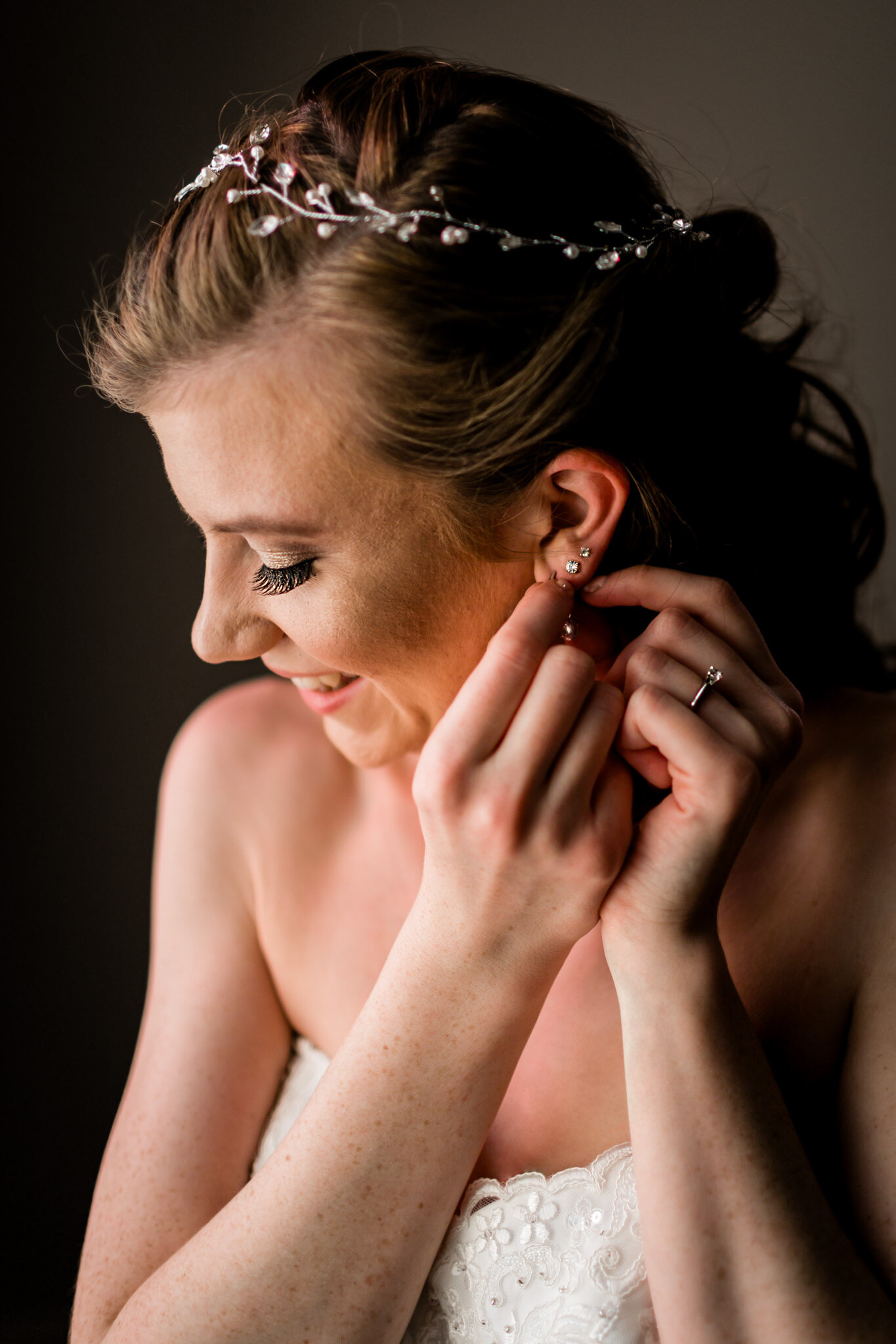 Durham Wedding Photographer | By G. Lin Photography | Bride putting on earrings next to window