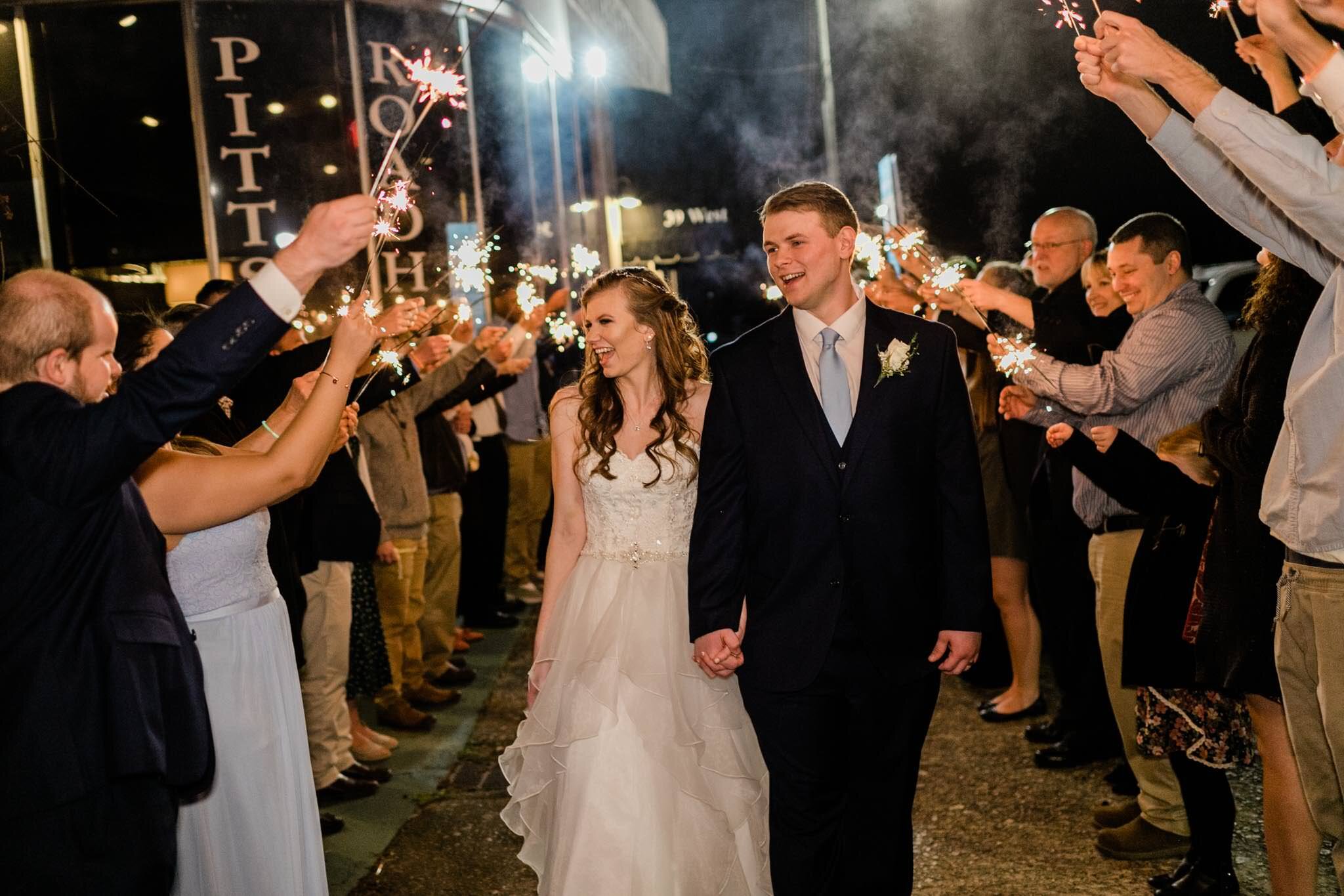 Durham Wedding Photographer | By G. Lin Photography | Bride and groom looking at guests and laughing during sparkler sendoff