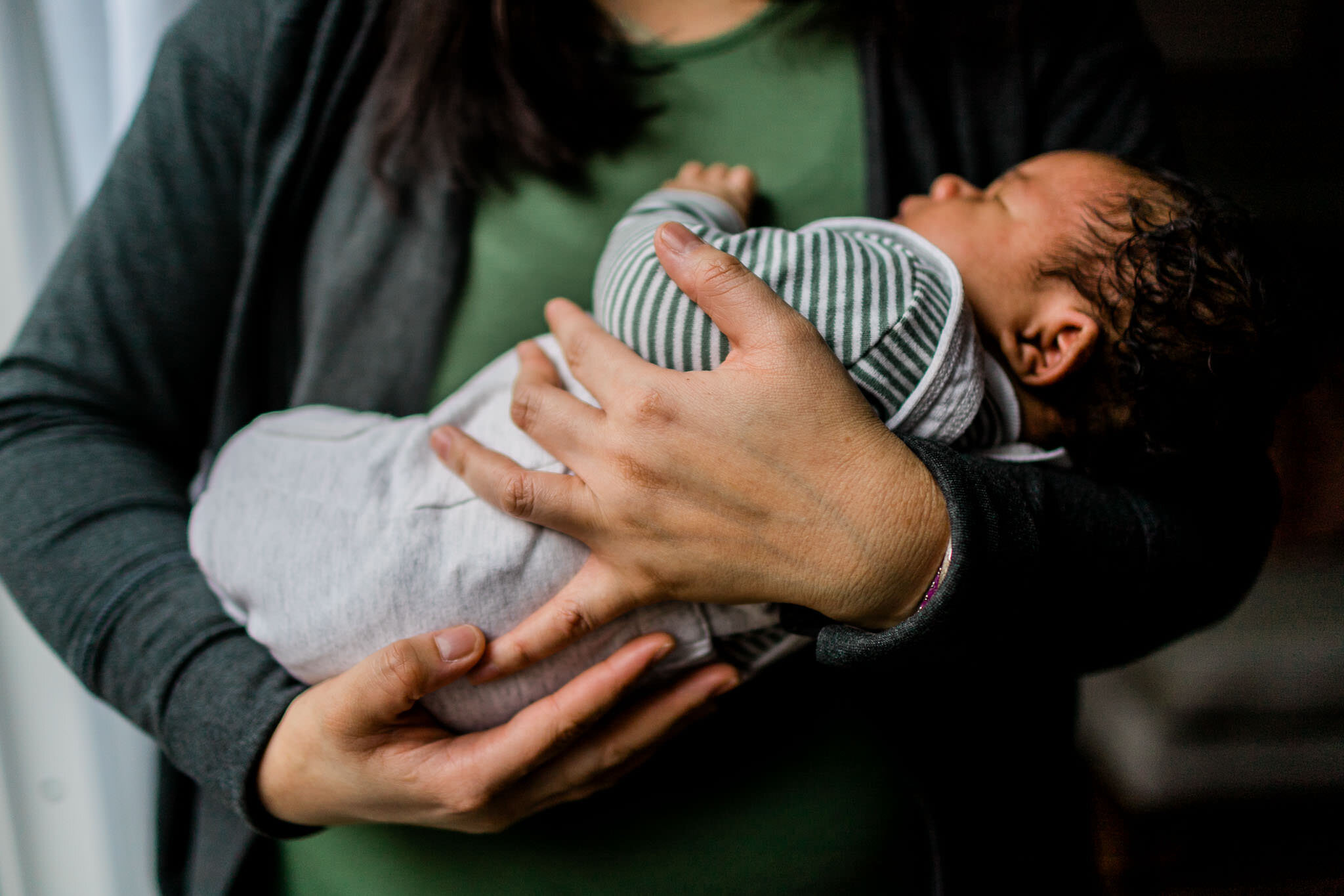 Raleigh Newborn Photographer | By G. Lin Photography | Mother holding baby boy in her arms