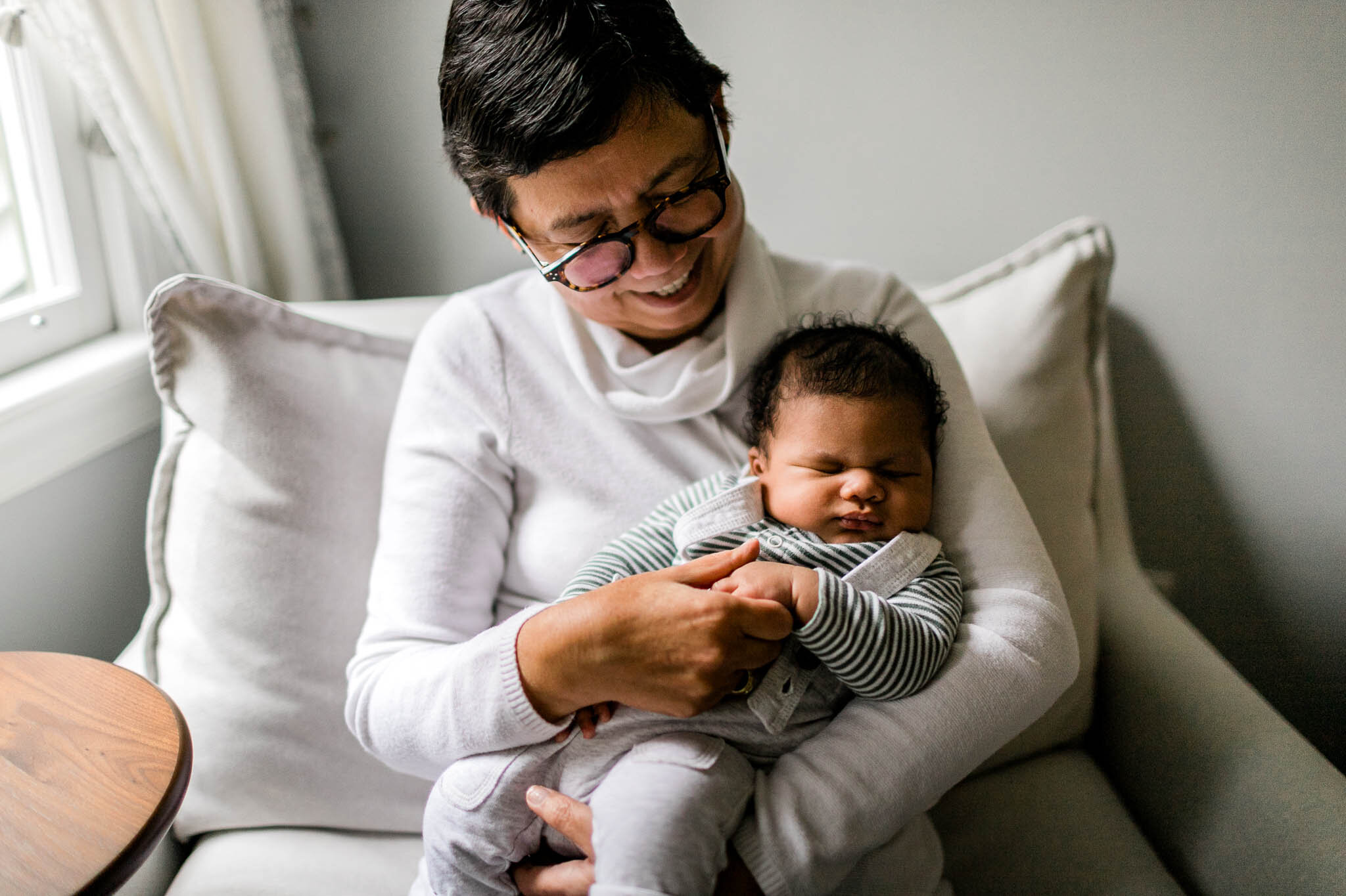 Durham Newborn Photographer | By G. Lin Photography | Grandma holding grandson on couch