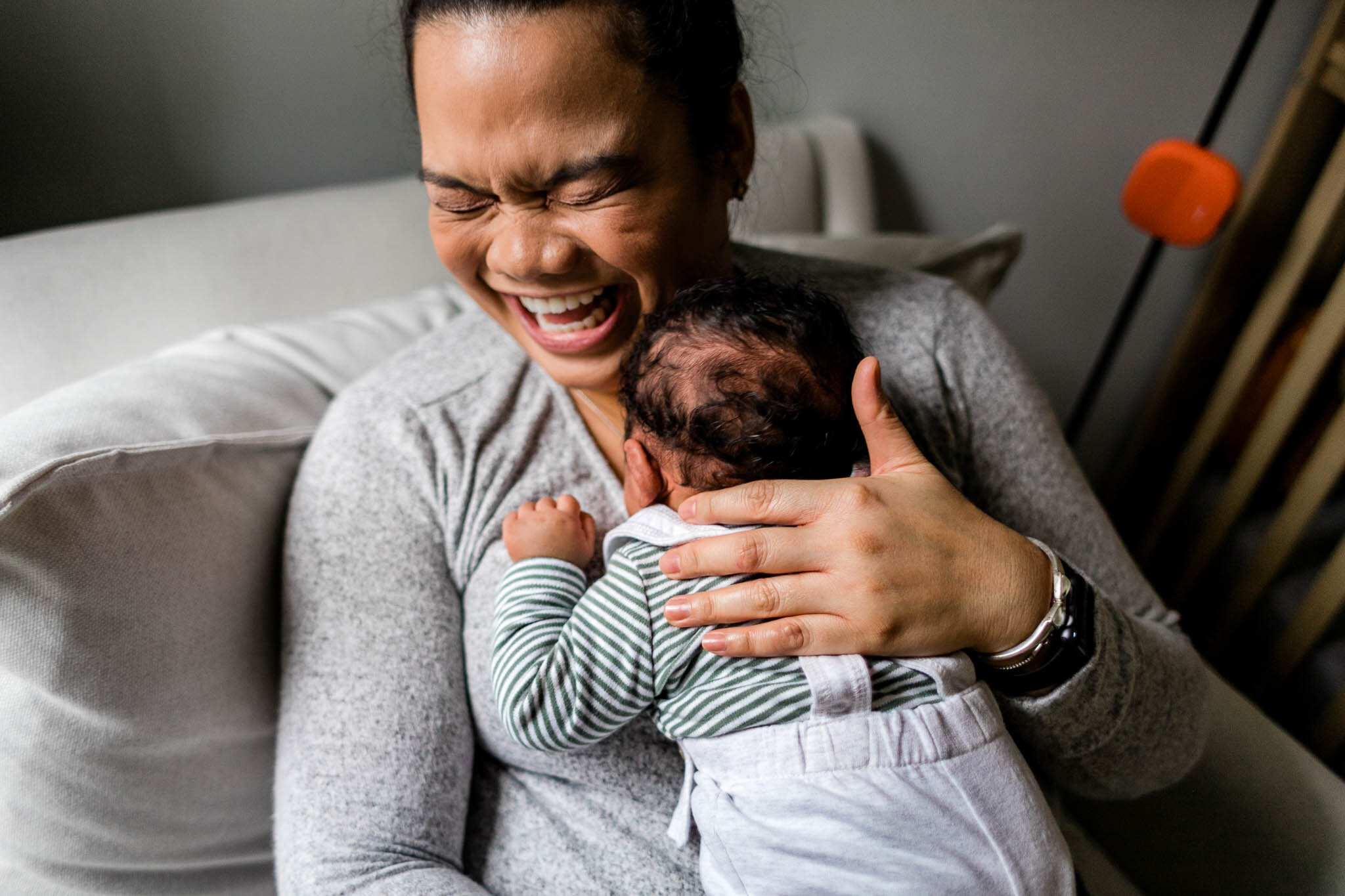 Durham Newborn Photographer | By G. Lin Photography | Mother holding baby boy and laughing