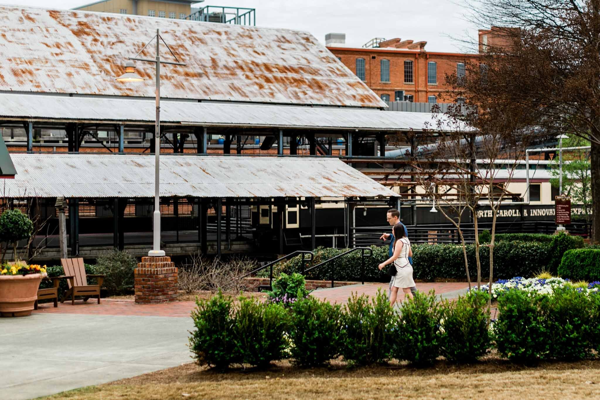 Durham Engagement Photographer | By G. Lin Photography | Couple walking at American Tobacco Campus