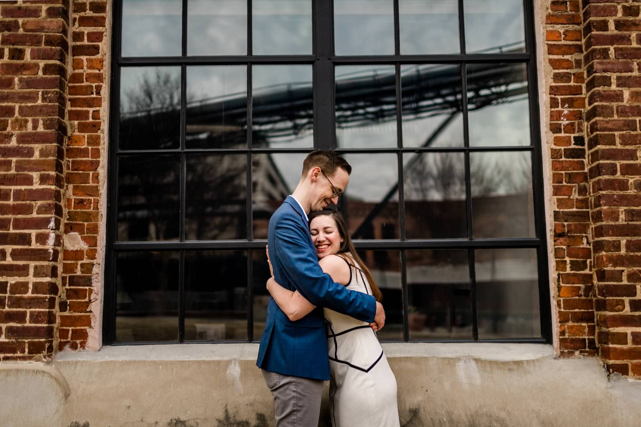Durham Engagement Photographer | By G. Lin Photography | Couple hugging with beautiful brick wall in background