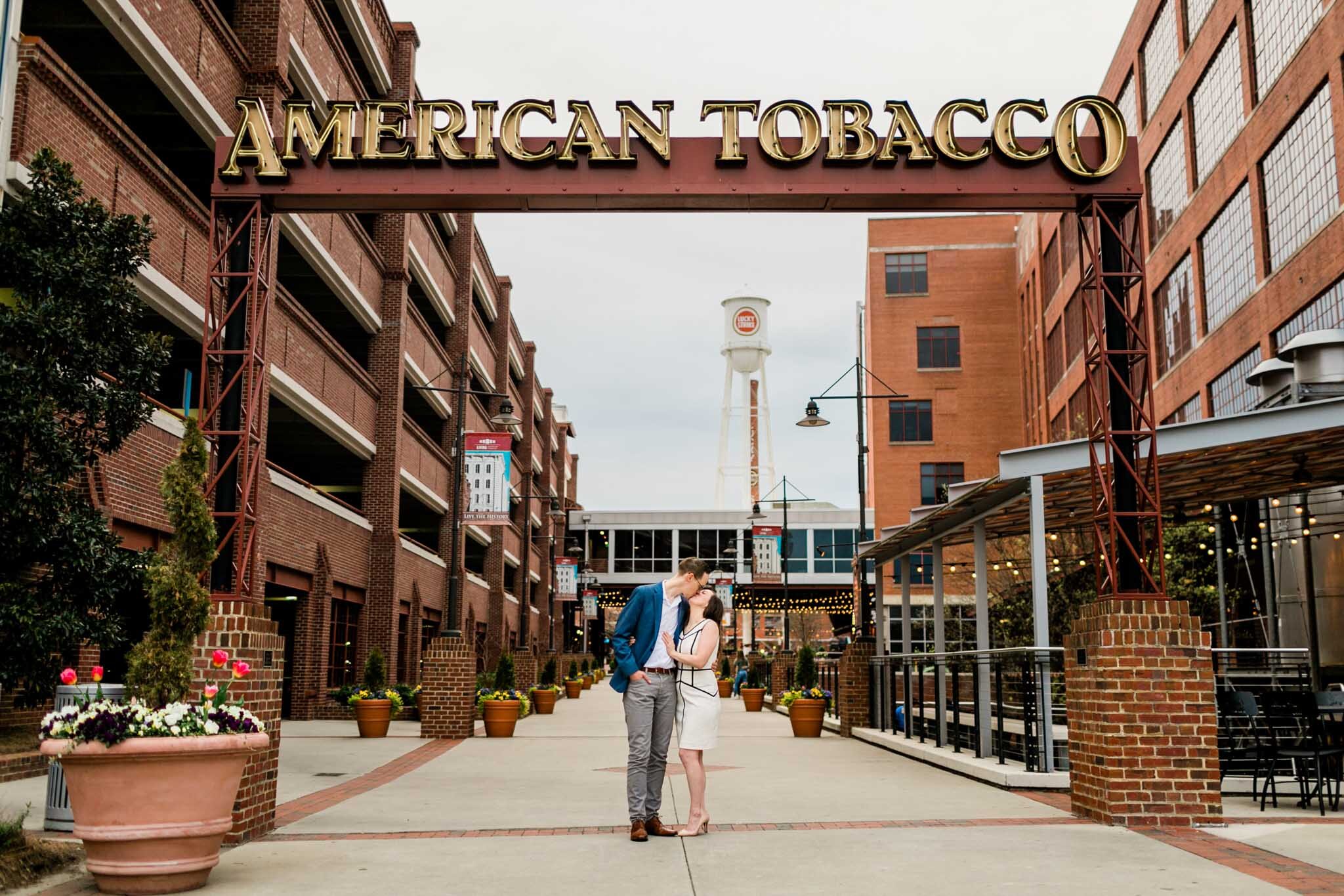 Durham Engagement Photographer | By G. Lin Photography | Couple standing at entrance of American Tobacco Campus