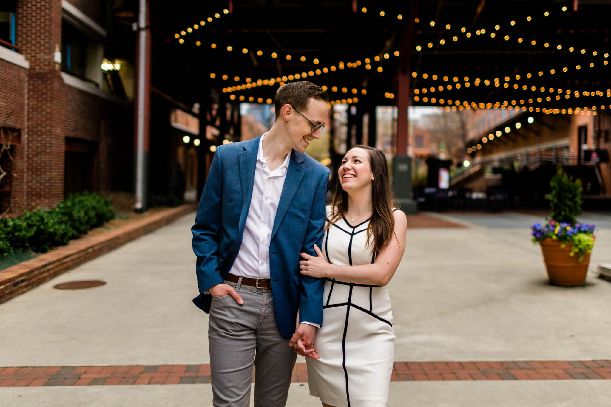 Durham Engagement Photographer | By G. Lin Photography | Couple holding hands and walking down American Tobacco Campus