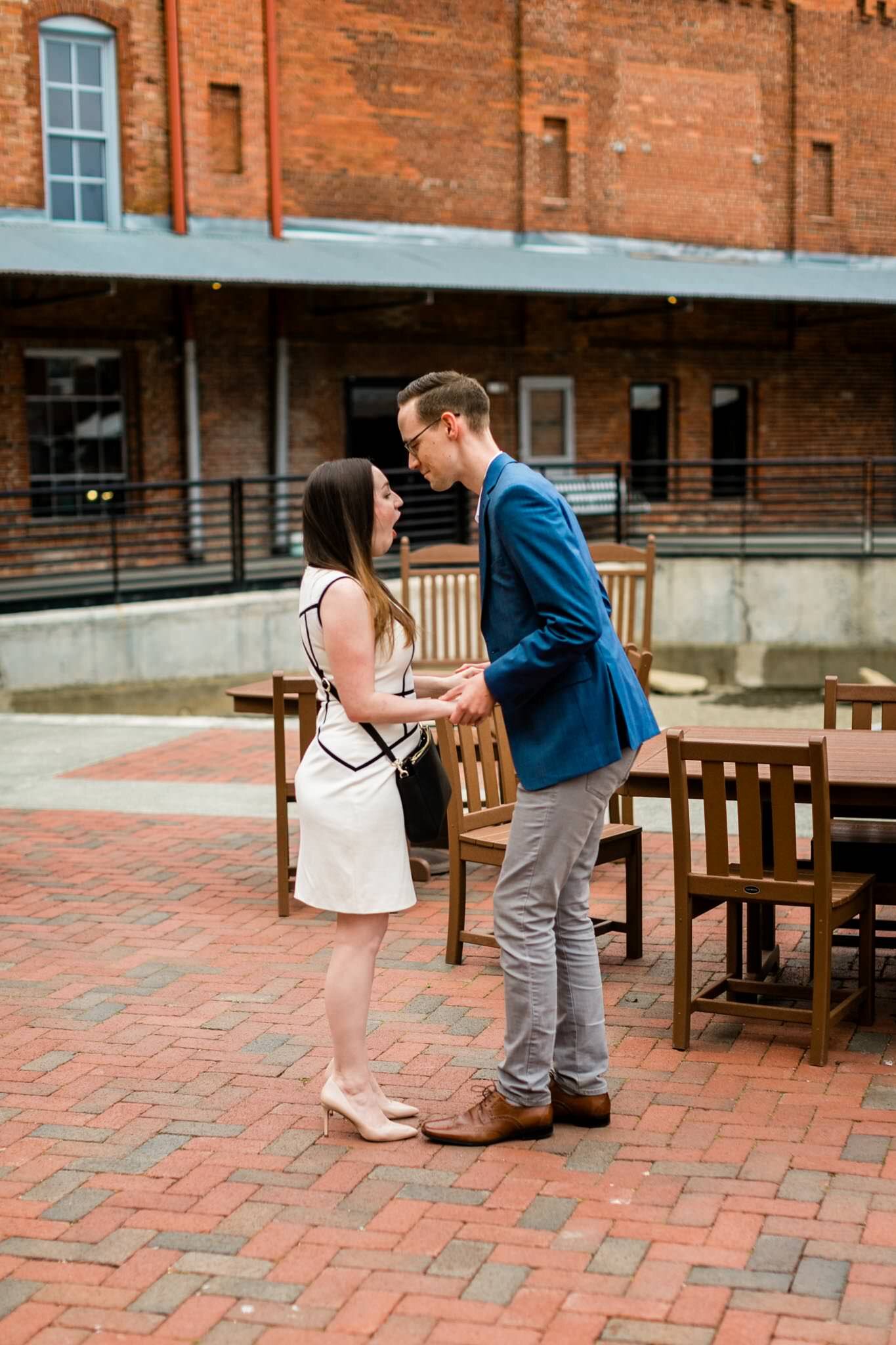 Durham Engagement Photographer | By G. Lin Photography | Man getting down on one knee to propose | American Tobacco Campus