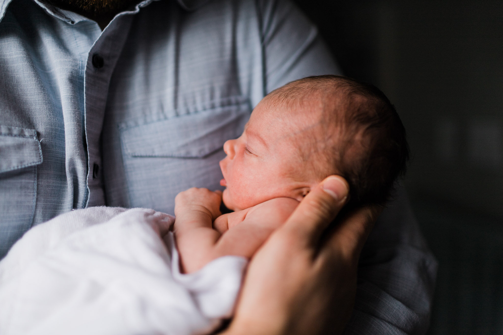 Raleigh Newborn Photographer | By G. Lin Photography | Father cradling baby daughter in his arms