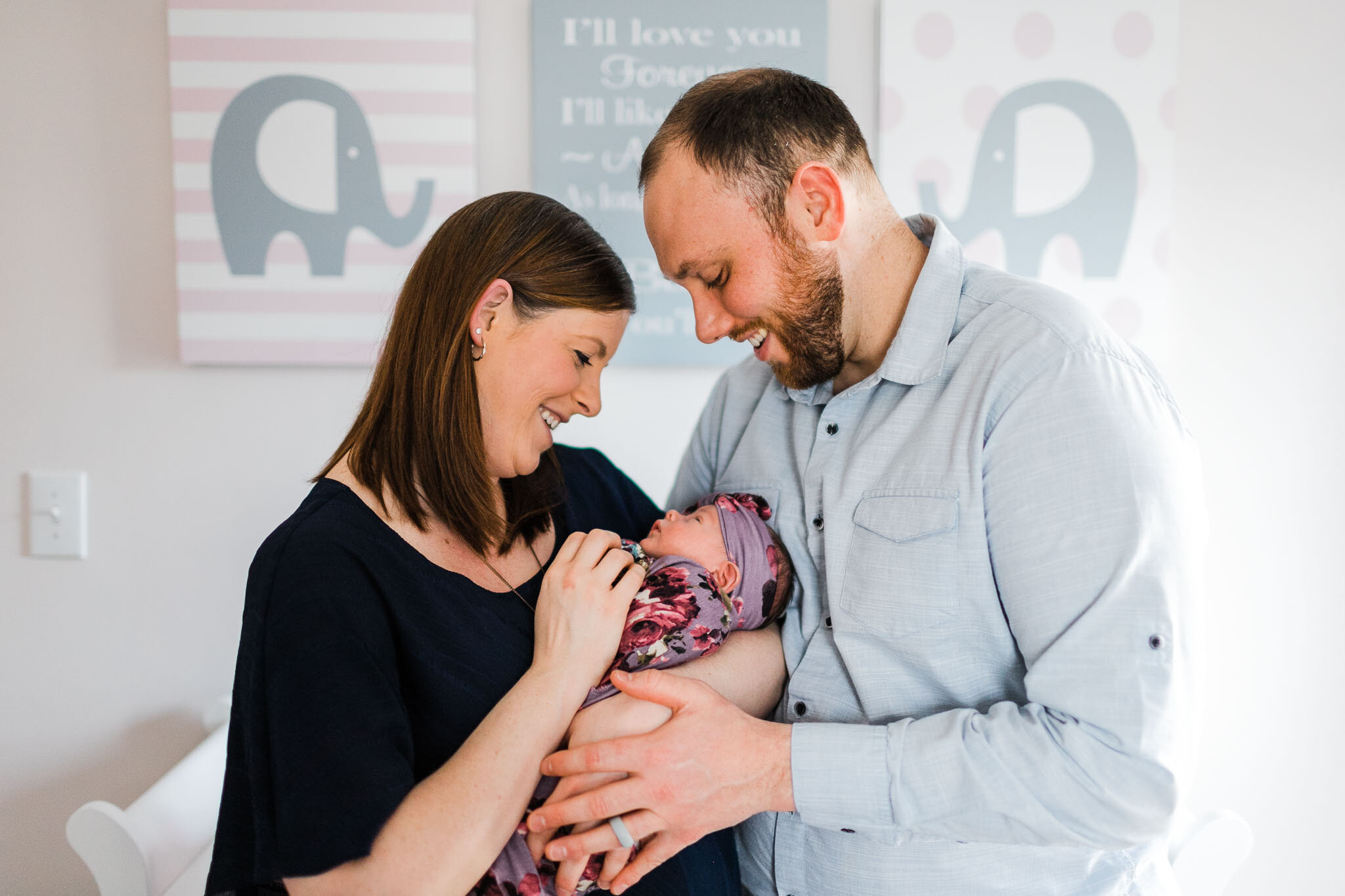 Raleigh Newborn Photographer | By G. Lin Photography | Parents holding baby in white nursery