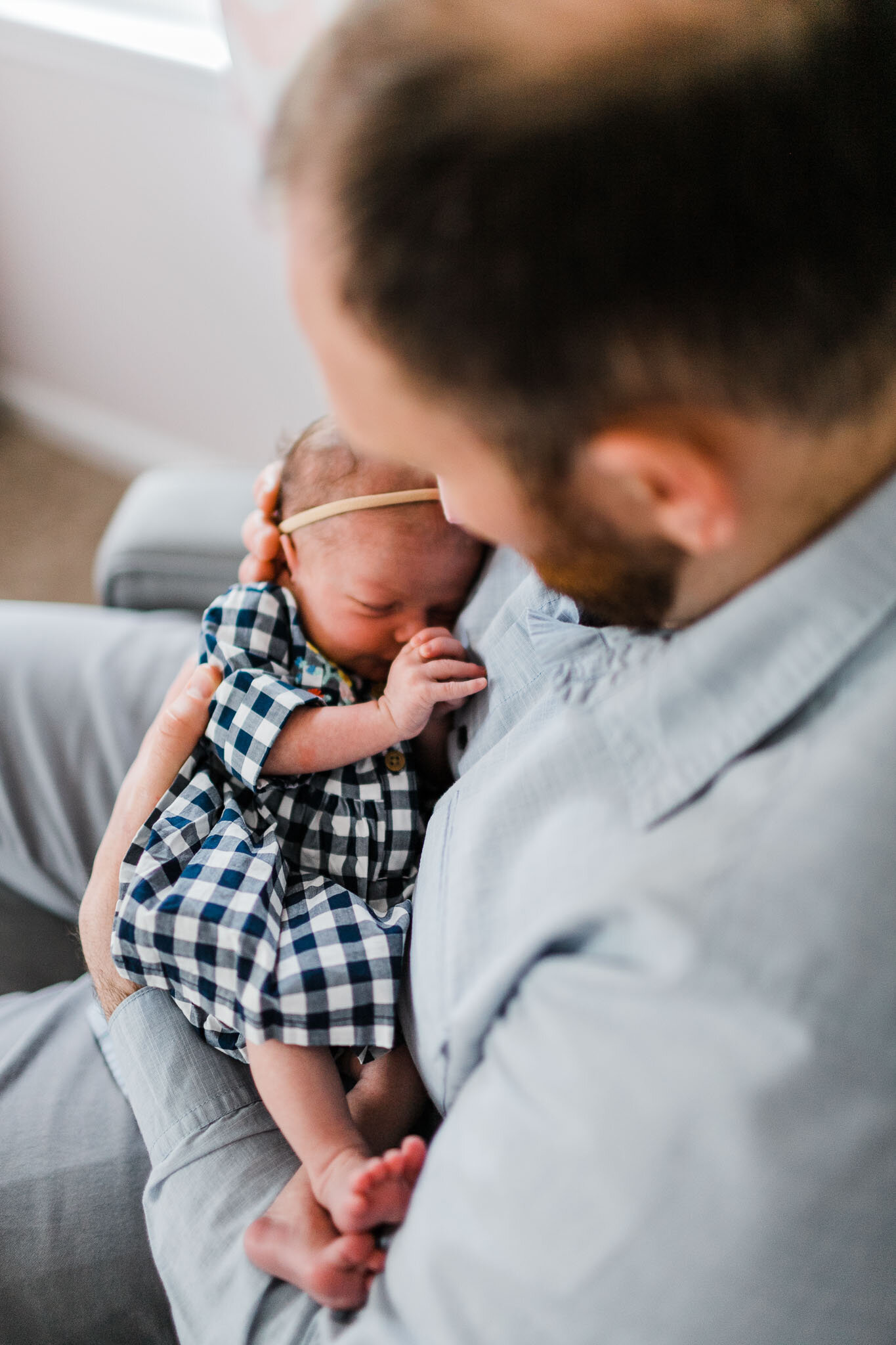 Raleigh Newborn Photographer | By G. Lin Photography | Father holding baby in nursery