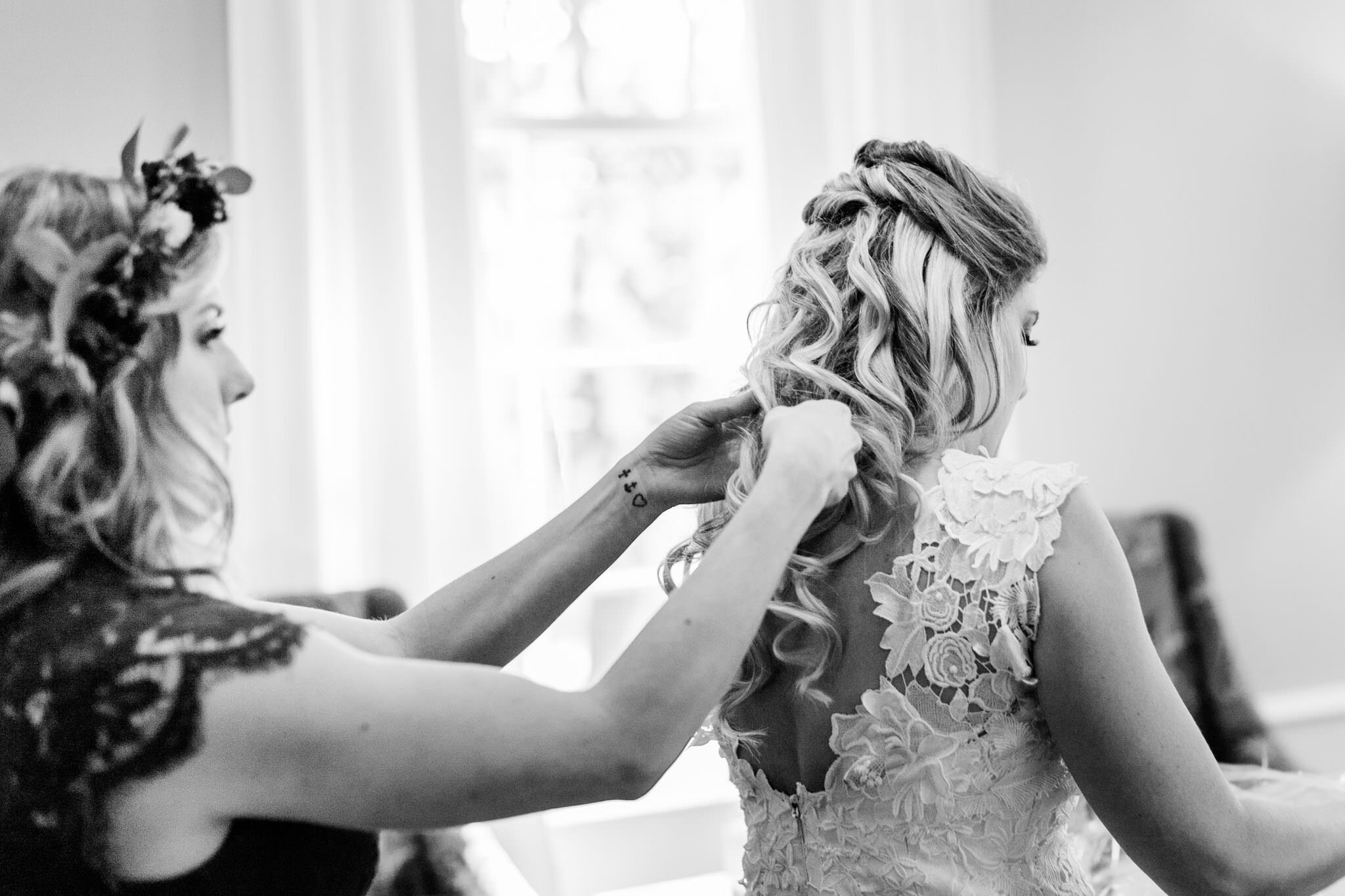 Durham Wedding Photographer | By G. Lin Photography | Black and white image of bridesmaid putting necklace on bride