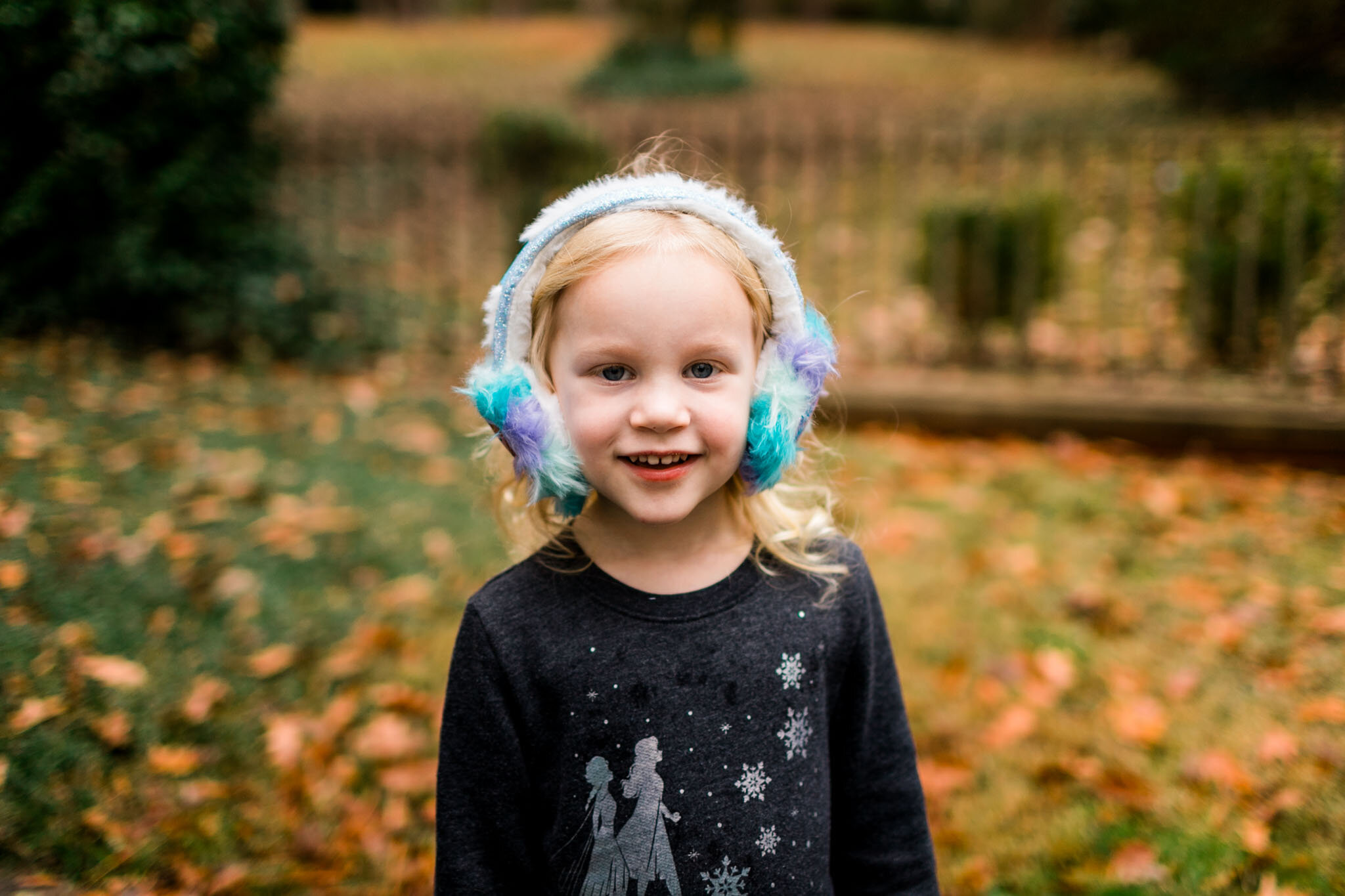 Durham Family Photographer | By G. Lin Photography | Girl wearing earmuffs and smiling