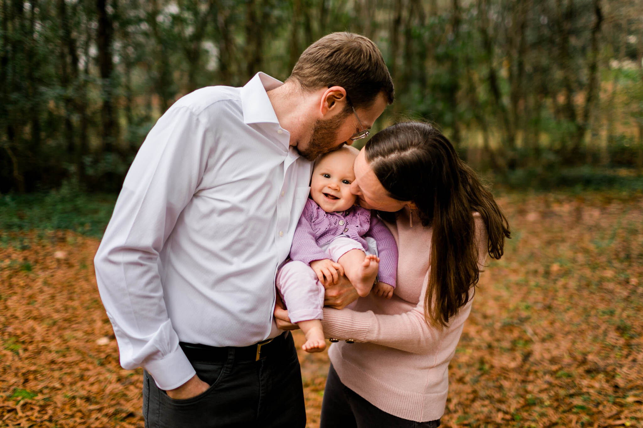 Durham Family Photographer | By G. Lin Photography | Parents holding baby and kissing her cheeks