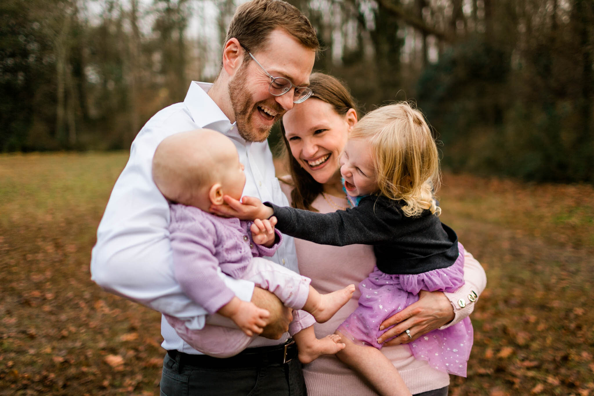 Durham Family Photographer | By G. Lin Photography | Candid family portrait outside in grassy area