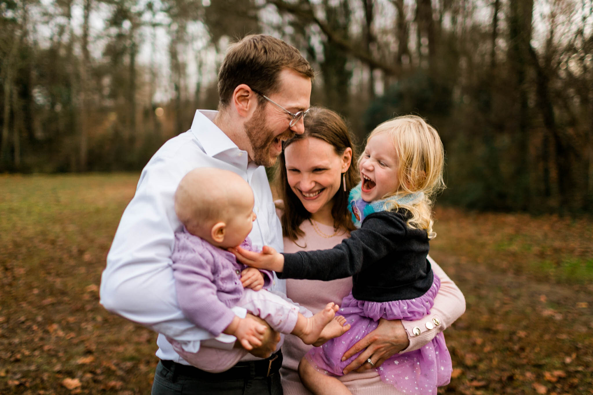 Durham Family Photographer | By G. Lin Photography | Family laughing together outside in grassy area