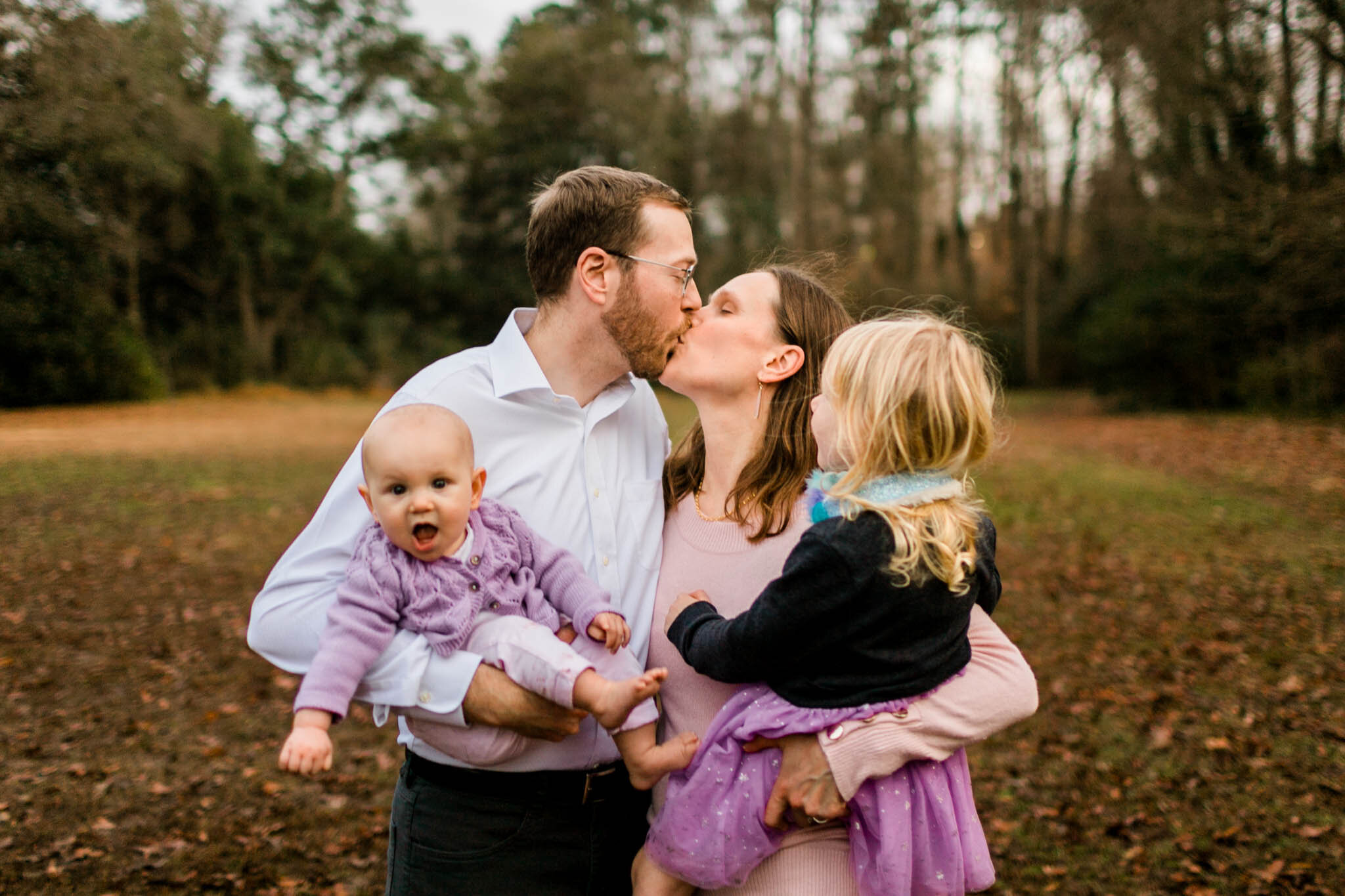 Durham Family Photographer | By G. Lin Photography | Parents kissing while holding children
