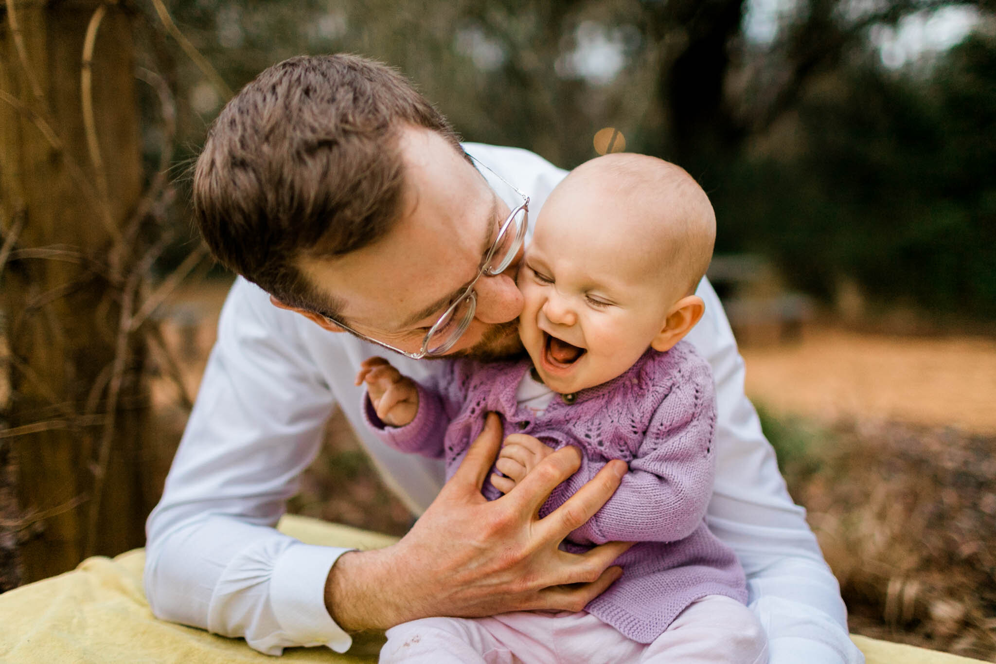 Durham Family Photographer | By G. Lin Photography | Father kissing baby girl on cheeks