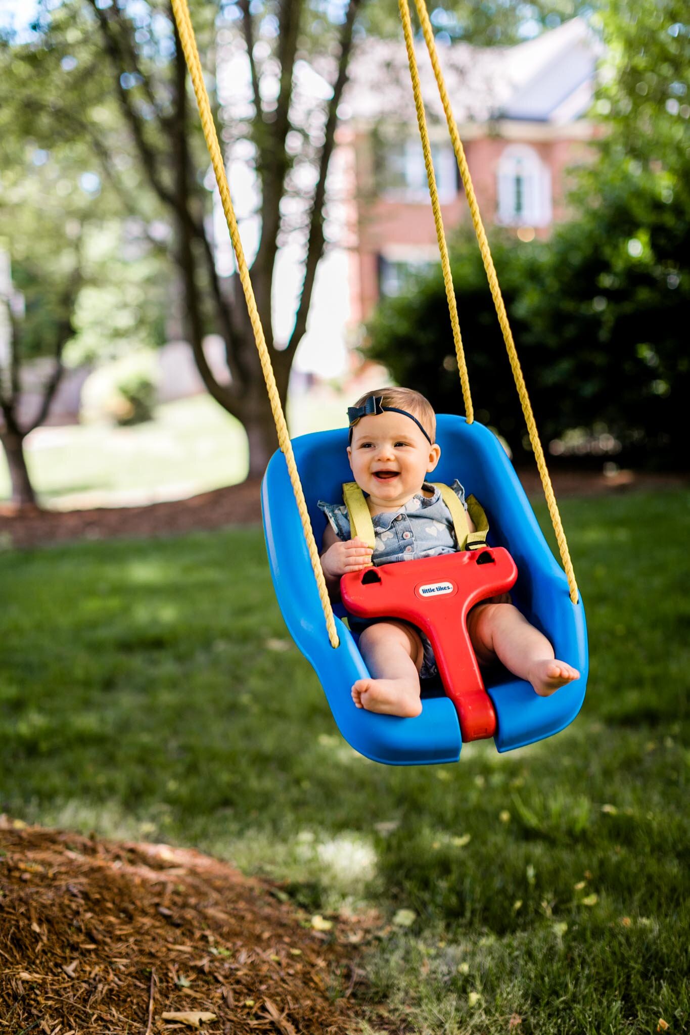 Raleigh Family Photographer | By G. Lin Photography | Baby girl sitting in swing and laughing