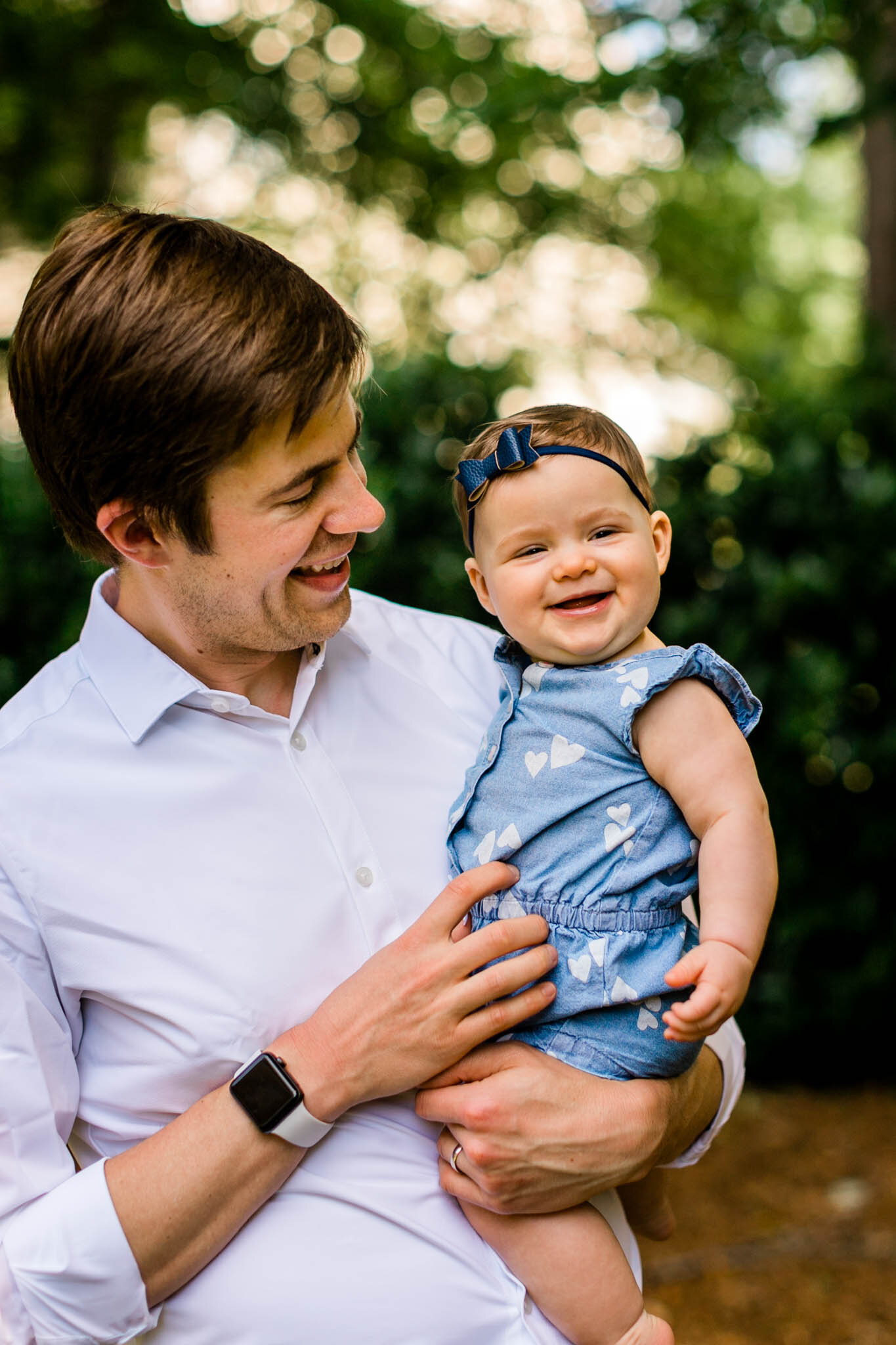 Raleigh Family Photographer | By G. Lin Photography | Father holding baby girl and smiling