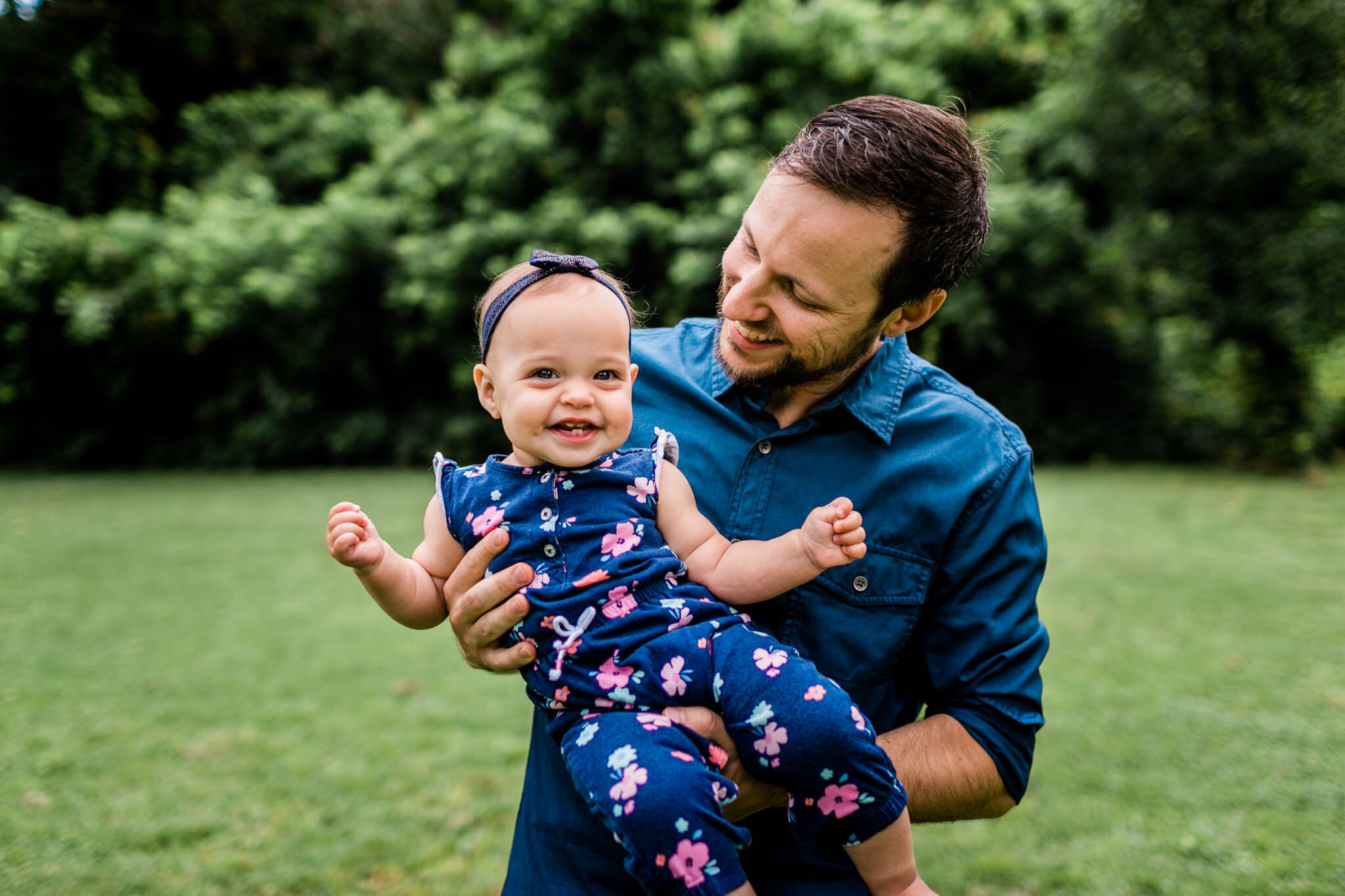 Raleigh Family Photographer | By G. Lin Photography | Dad holding baby girl in his arms